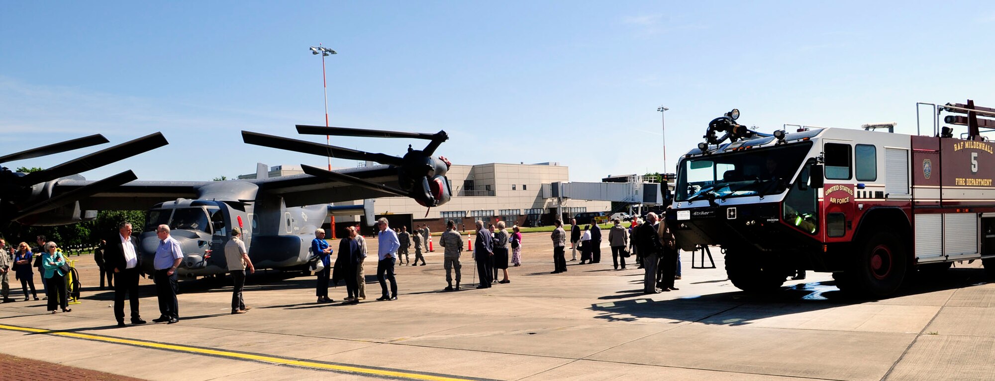 A CV-22 Osprey from the 352nd Special Operations Group and a fire truck from the 100th Civil Engineer Squadron Fire Department are on display for the Retiree Appreciation Day event June 6, 2014, on RAF Mildenhall, England. Retirees living in the United Kingdom came together for the event which brought them up-to-date with current events and benefits. (U.S. Air Force photo/Karen Abeyasekere/Released)

