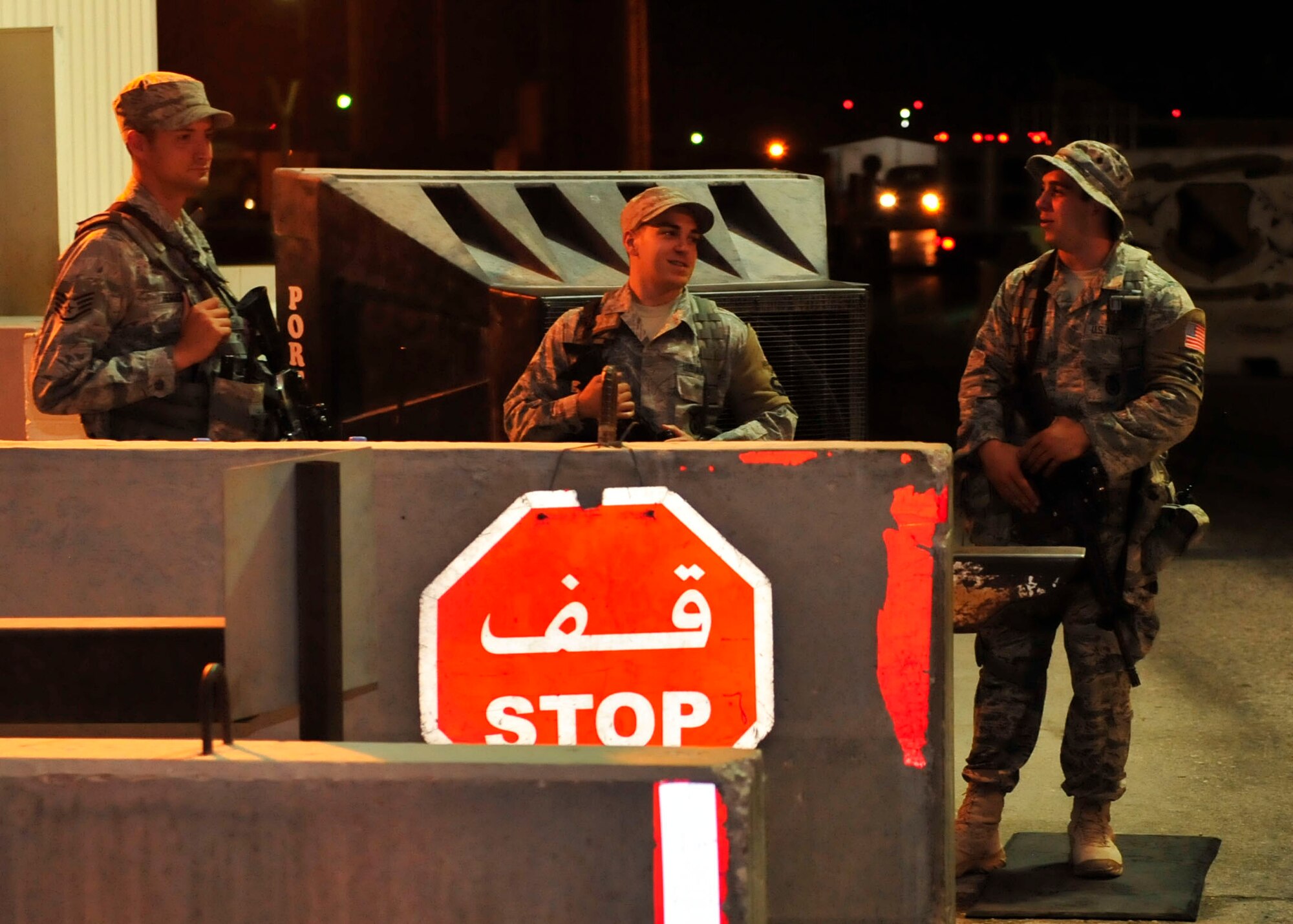 U.S Air Force Staff Sgt. David Herrera, Senior Airman Ryan Heredia, and Airman 1st Class Andrew Haydar, 379th Expeditionary Security Forces Squadron patrolmen, stand post during a night shift at Al Udeid Air Base, Qatar, June 12, 2014. Herrera is deployed from Joint Base San Antonio in San Antonio, Texas and his hometown is Sacramento, California.  Heredia is deployed from Eglin Air Force Base in Florida, and his hometown is West Palm Beach, Florida. Haydar is deployed from Columbus Air Force Base, Mississippi and his hometown is Miami. (U.S. Air Force photo by Senior Airman Colin Cates)