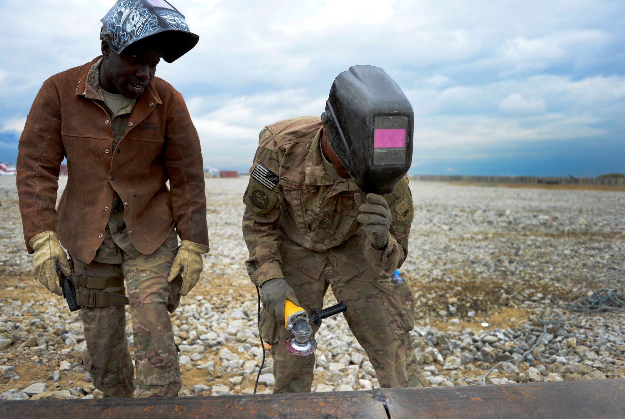 U.S. Air Force Staff Sgt. William Thomas and Airman 1st Class Demetrius Brown, 577th Expeditionary Prime Base Engineer Emergency Force Squadron troop construction bravo, look over the drainage pipe after grinding down the weld at Bagram Air Base, Afghanistan, May 17, 2014. The drainage pipe will assist in keeping the helicopter landing zone free of water. Thomas, a Cincinnati, Ohio native is deployed from the 786th Civil Engineer Squadron, Ramstein Air Base, Germany and Brown a native of Killeen, Texas deployed from the 355th Civil Engineer Squadron Davis-Monthan Air Force Base, Arizona. (U.S. Air Force photo by Senior Airman Sandra Welch)