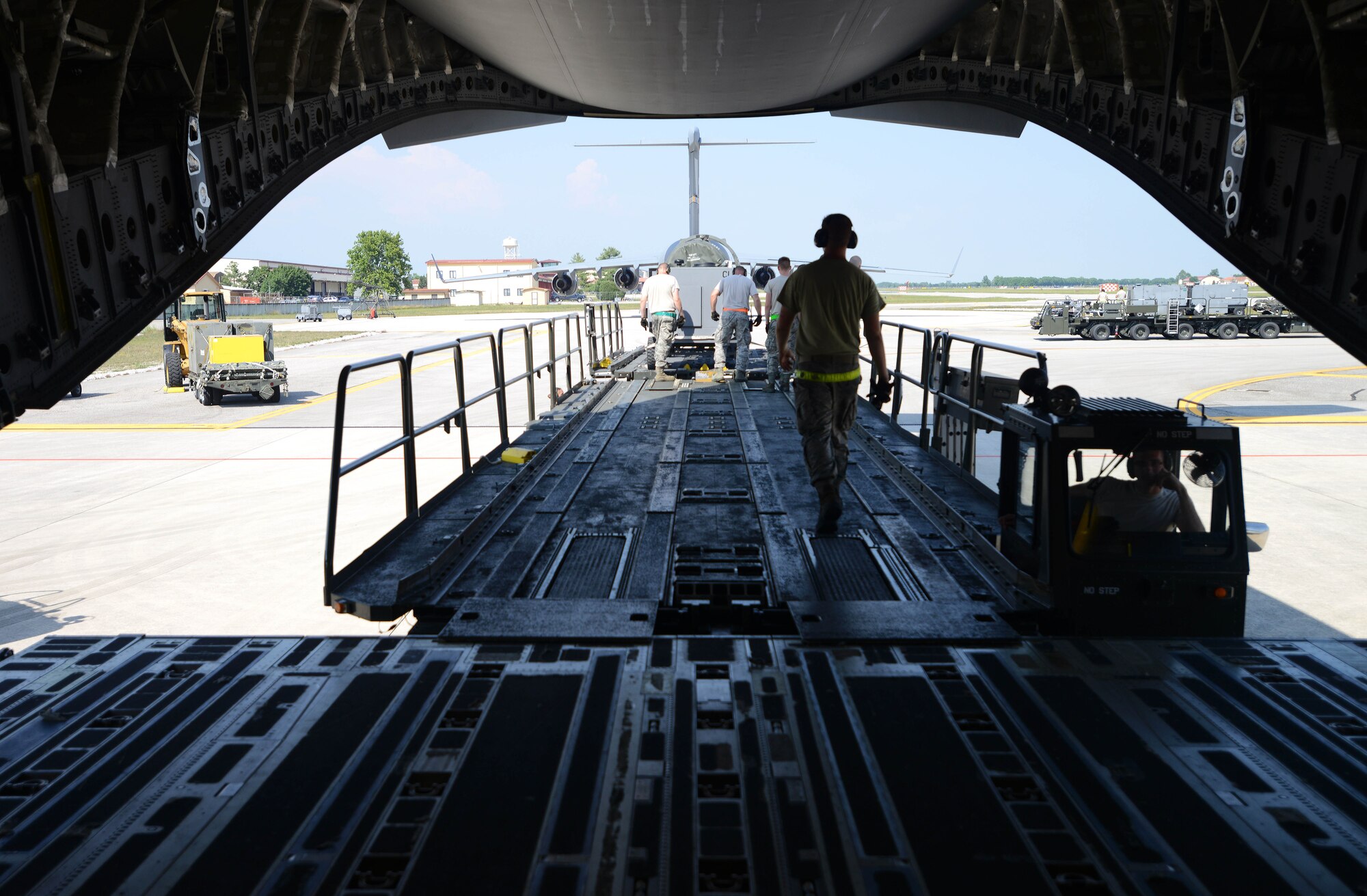 Airmen from the 31st Fighter Wing load supplies on a C-17 Globemaster III before its departure from Aviano Air Base, Italy, in support of Exercise Red Flag, June, 10, 2014. Red Flag is conducted at Nellis Air Force Base, Nev., and was established in 1975 as an initiative to prepare forces in combined air, ground, space and electronic threat environments. (U.S Air Force photo/Airman 1st Class Deana Heitzman) 