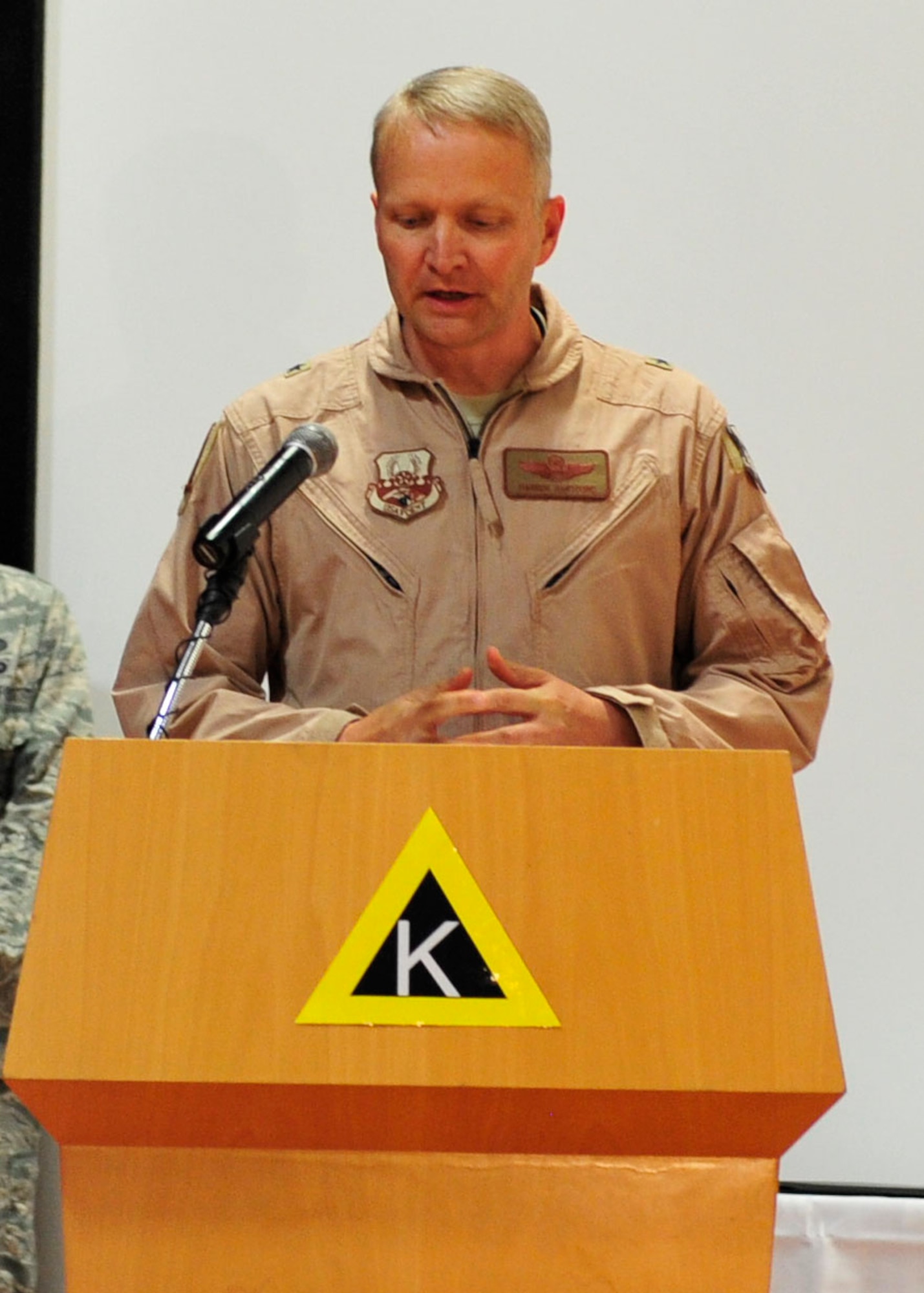 U.S. Air Force Brig. Gen. Darren Hartford, 379th Air Expeditionary Wing commander, addresses the audience for the first time after assuming command during the change of command ceremony at Al Udeid Air Base, Qatar, June 12, 2014. Hartford’s priorities as commander are mission, Airmen and our partners. (U.S. Air Force photo by Senior Airman Colin Cates) 