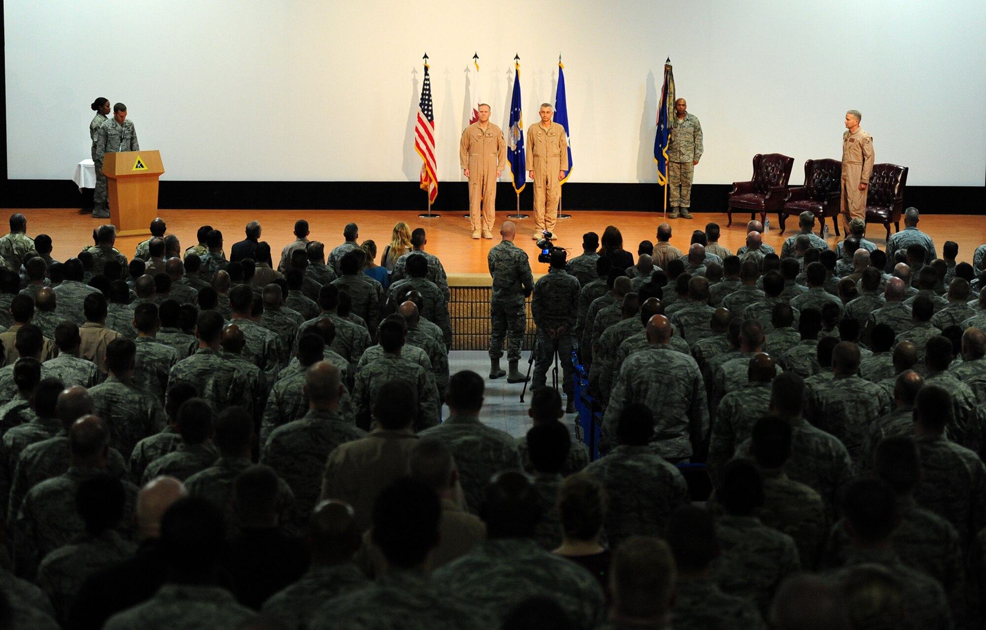U.S. Air Force Maj. Gen. Jeffrey Lofgren, U.S. Air Forces Central Command deputy commander, and Brig. Gen. Roger H. Watkins, 379th Air Expeditionary Wing outgoing commander, stand at attention for the presentation of the Bronze Star Medal during the wing change of command ceremony at Al Udeid Air Base, Qatar, June 12, 2014. Watkins is headed to the Joint Warfare Center, Supreme Allied Command for Transformation as the deputy commander and chief of staff in Stavanger, Norway. (U.S. Air Force photo by Staff Sgt. Ciara Wymbs)