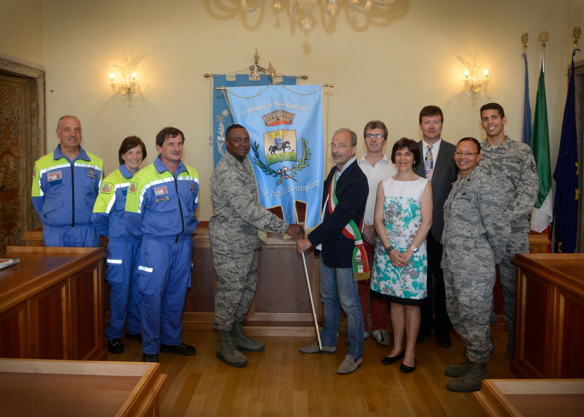 The Mayor of San Quirino, Corrado Della Mattia, presents the Eco-Templari flag to Col. Harry Lane, 31st Mission Support Group commander, in recognition of Aviano Air Base winning the San Quirino Ecoligical Day annual clean-up, June 6, 2014 in San Qurino, Italy. The flag is awarded to the team who collected the most trash during the event and is a duplicate of the city’s official flag. Volunteers from Team Aviano collected more than 350 pounds of debris and trash during the clean up event, March 29.  (U.S. Air Force photo/ Staff Sgt. Jessica Hines) 