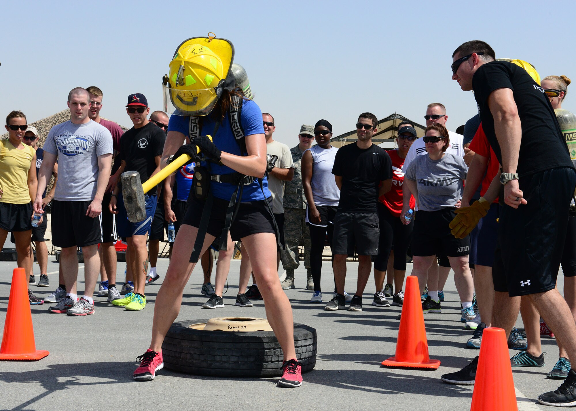 A Service member competes in a fire muster competition at Al Udeid Air Base, Qatar, June 7, 2014. The competition is an obstacle course that had seven stations where each team was timed to complete the fastest. (U.S. Air Force photo by Staff Sgt. Ciara Wymbs) 