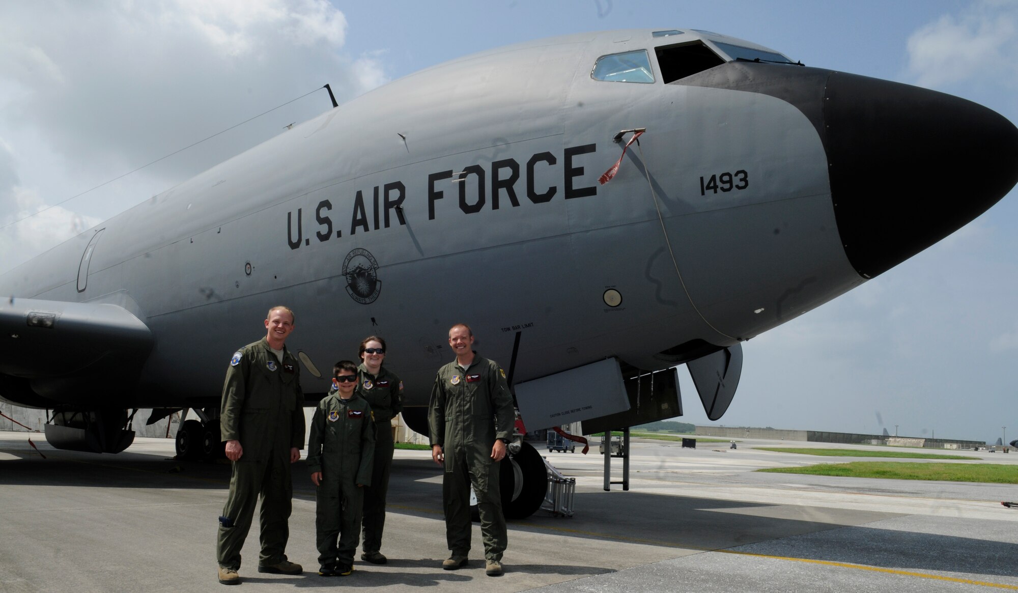 Peter Denham "Pilot for a Day" and members from the 909th Air Refueling Squadron pose for a group photo after reviewing the various parts of a KC-135 Stratotanker, on the flightline of Kadena Air Base, Japan, June 12, 2014. Peter was a part of the Pilot for a Day program, which devotes an entire day for local children with serious or chronic conditions and gives them a chance to experience the U.S. Air Force. (U.S. Air Force photo Airman 1st Class Keith James)