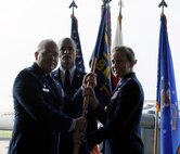 U.S. Air Force Col. Jeffrey King, 18th Maintenance Group commander, passes the guidon to Lt. Col. Laura Goodman, 718th Aircraft Maintenance Squadron commander, during the 718th AMXS change of command on Kadena Air Base, Japan, June 13, 2014. Goodman comes from the Pentagon, where she served as the Chief of Special Operations Branch, Weapons Systems Division for the Air Force Director of Logistics. (U.S. Air Force photo by Airman 1st Class Keith James)