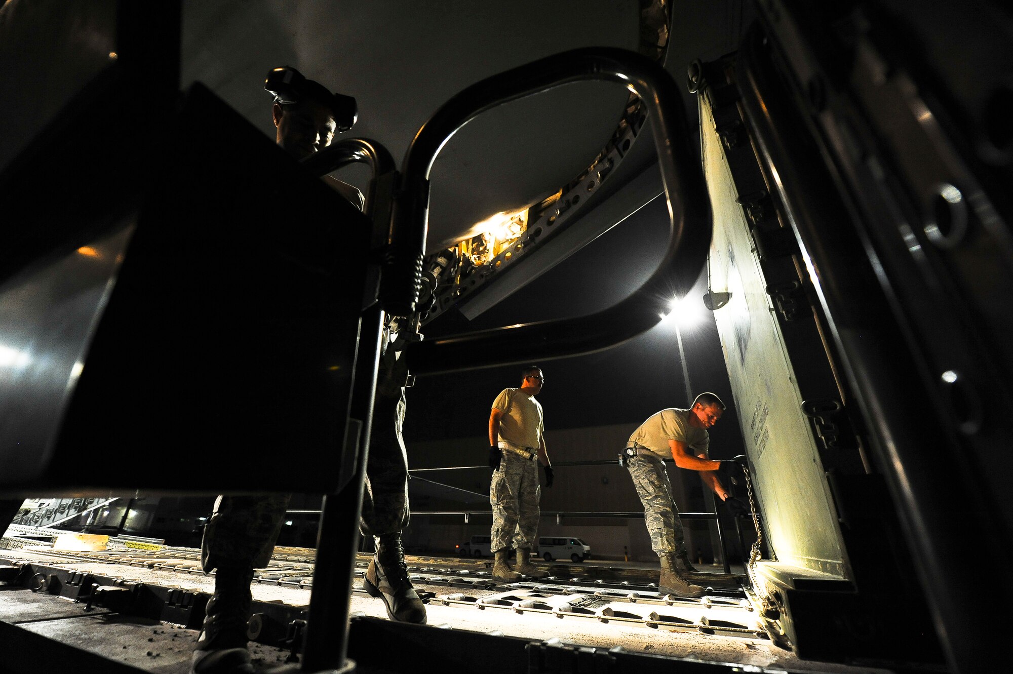 Airmen from the 380th Expeditionary Logistics Readiness Squadron Air Terminal Operations Center secure cargo to a Tunner 60K loader June 12, 2014, at an undisclosed location in Southwest Asia.  Almost all of the 380th Air Expeditionary Wing’s personnel and equipment pass through ATOC. (U.S. Air Force photo by Tech. Sgt. Russ Scalf/Released)