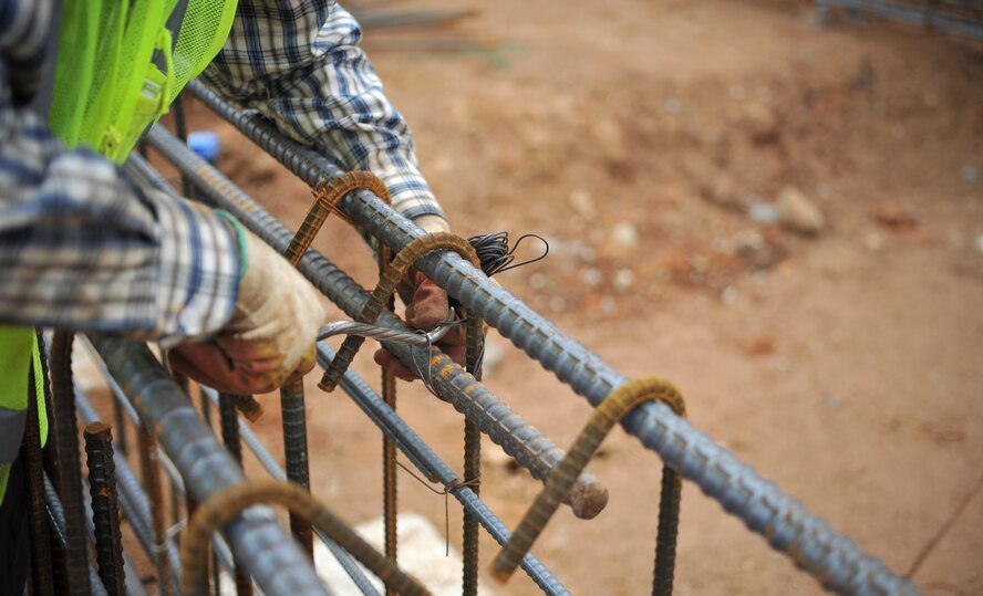 A construction worker secures rebar to a form prior to pouring concrete at the site for a new elementary school on Osan Air Base, Republic of Korea, June 5, 2014. The $30 million project is being supervised by the U.S. Army Corps of Engineers Osan Resident Office. (U.S. Air Force photo/Airman 1st Class Ashley J. Thum)
