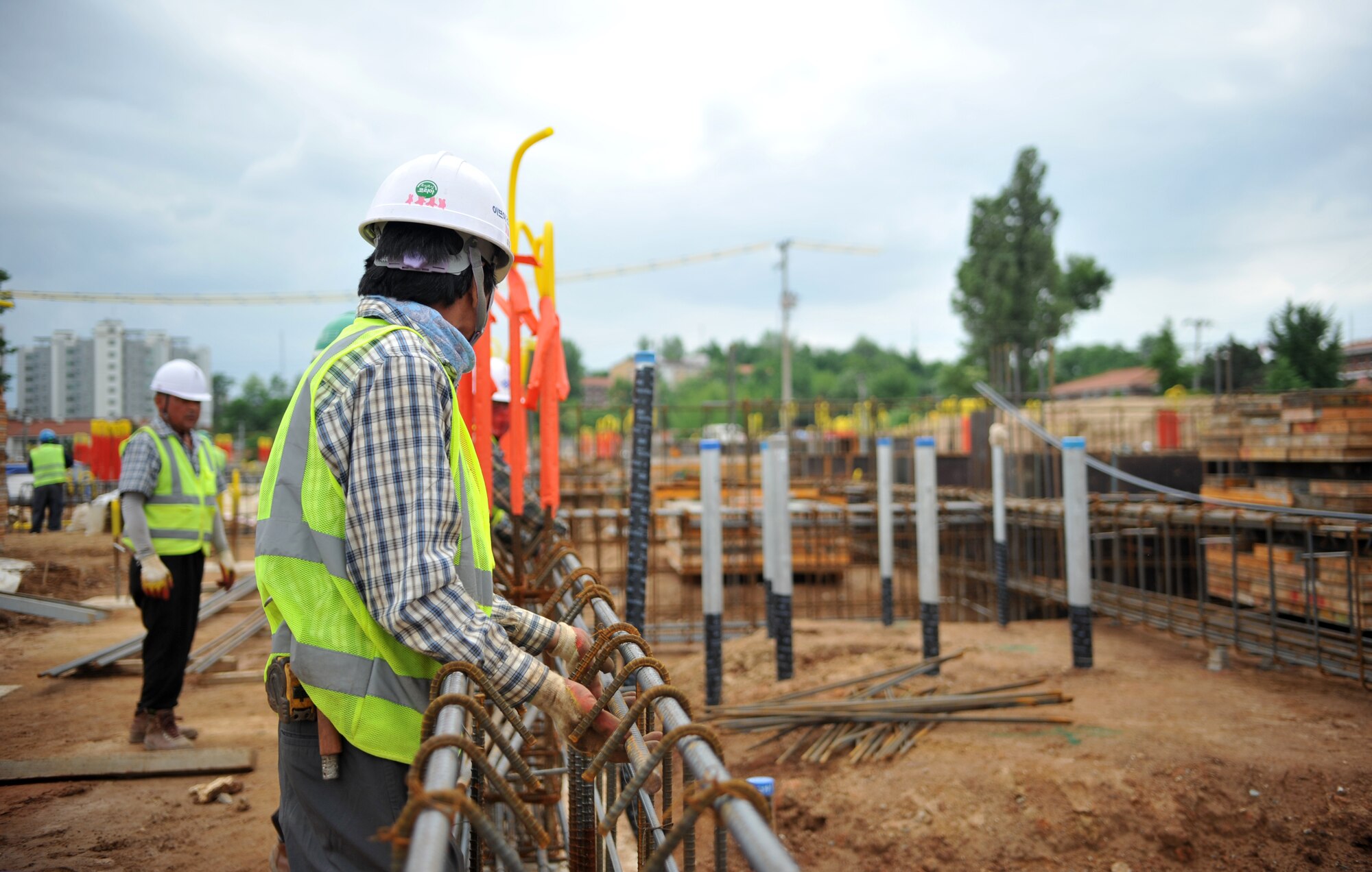 Construction workers lay rebar forms prior to pouring concrete at the site for a new elementary school on Osan Air Base, Republic of Korea, June 5, 2014. The school will feature a 21st century design to enhance students’ learning opportunities and is scheduled to be completed in early 2016. (U.S. Air Force photo/Airman 1st Class Ashley J. Thum)