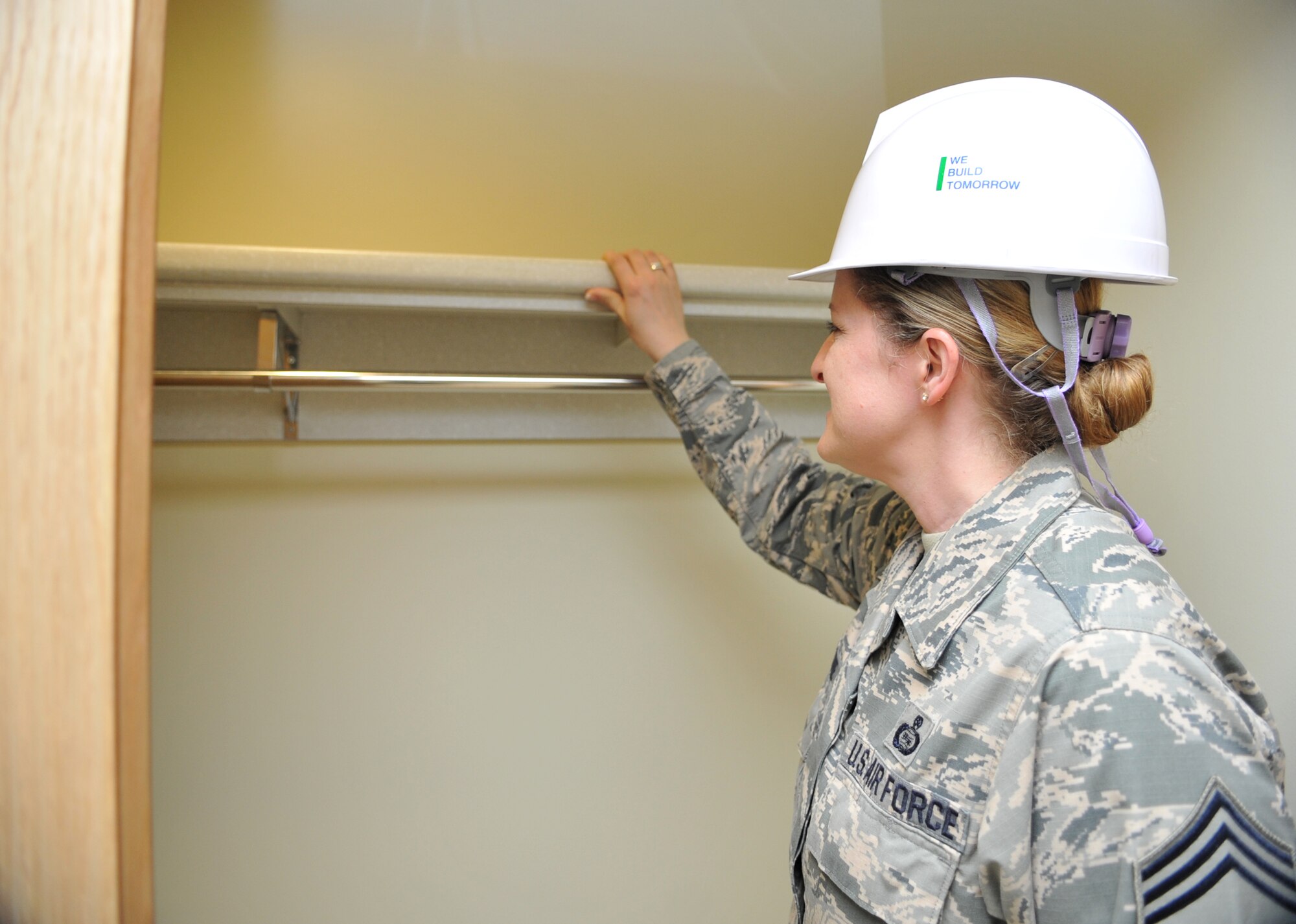 Chief Master Sgt. Kathlina Racine, 303rd Intelligence Squadron superintendent, inspects the closet inside the mock-up room of a new senior NCO dormitory on Osan Air Base, Republic of Korea, June 5, 2014. Chiefs and other leaders from across the base visited the facility that is scheduled to open near the end of 2014. (U.S. Air Force photo/Airman 1st Class Ashley J. Thum)