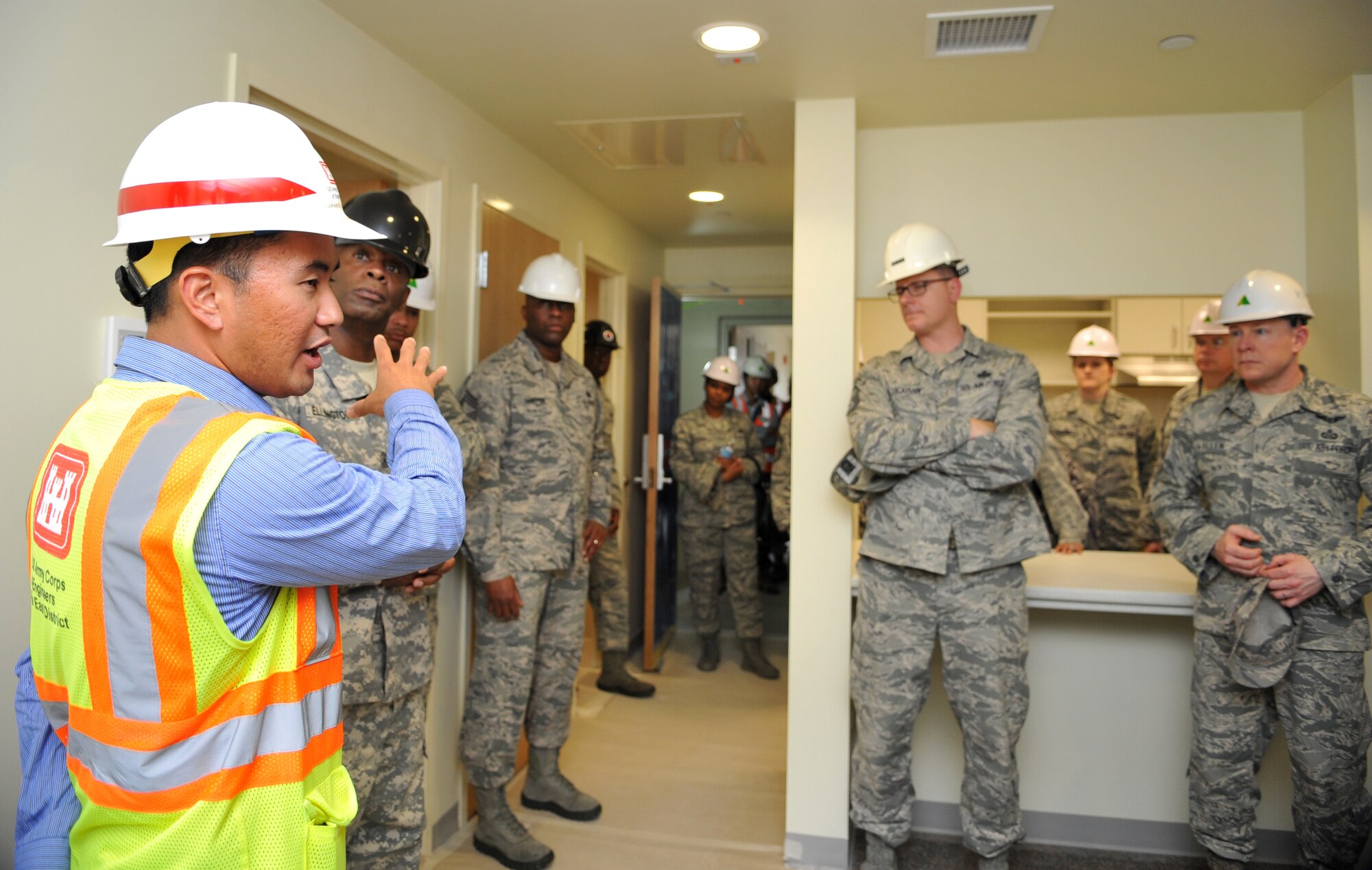 Jamie Hagio, U.S. Army Corps of Engineers Osan Resident Office resident engineer, discusses the construction progress of a new senior NCO dormitory on Osan Air Base, Republic of Korea, June 5, 2014. The facility is one of several projects managed by the USACE to enhance mission readiness and quality of life on base. (U.S. Air Force photo/Airman 1st Class Ashley J. Thum)