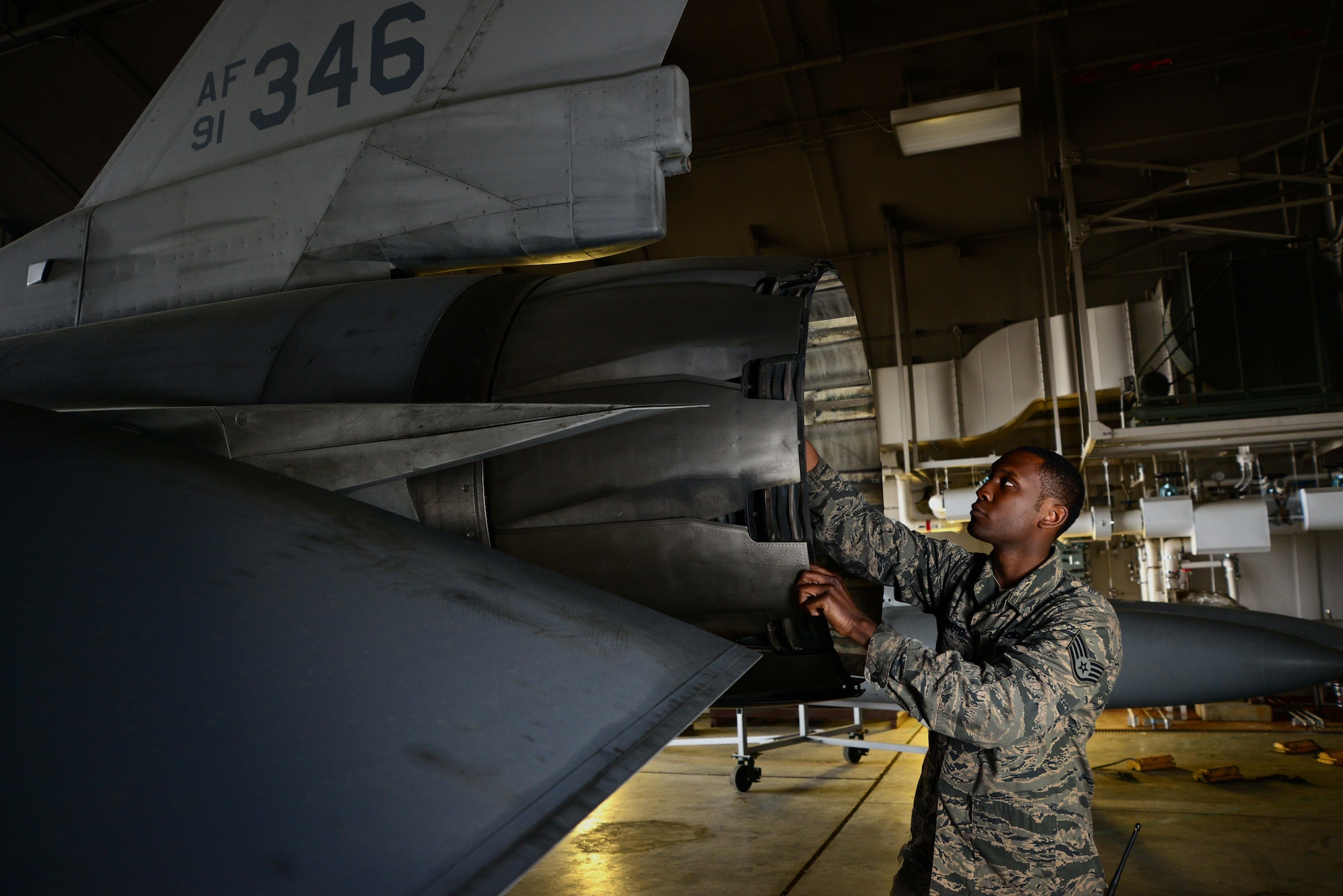 U.S. Air Force Staff Sgt. Jeremy Howard, 35th Aircraft Maintenance Squadron aerospace propulsion craftsman, inspects the exhaust of an F-16 Fighting Falcon at Misawa Air Base, Japan, June 6, 2014. Howard works with flightline aerospace propulsion and runs extensive tests on F-16 engines at Misawa using computer programs to analyze and monitor different parameters to ensure they’re functioning properly. (U.S. Air Force photo/Senior Airman Derek VanHorn)