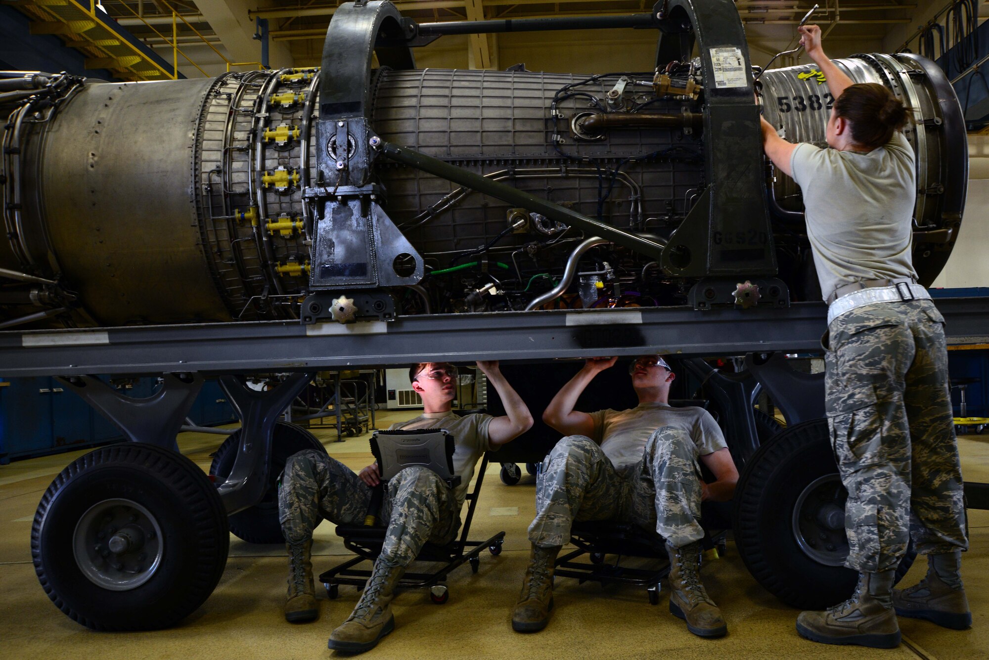From left: U.S. Air Force Airmen First Class Tyler Susskind, Robert Reindl and Airman Madison Mitchell, 35th Maintenance Squadron aerospace propulsion journeymen, put the finishing touches on an F-16 Fighting Falcon engine at Misawa Air Base, Japan, June 6, 2014. Aerospace Propulsion is known as “props,” and is responsible for all engine maintenance for not only Misawa AB, but Osan and Kunsan Air Bases in the Republic of Korea. (U.S. Air Force photo/Senior Airman Derek VanHorn)