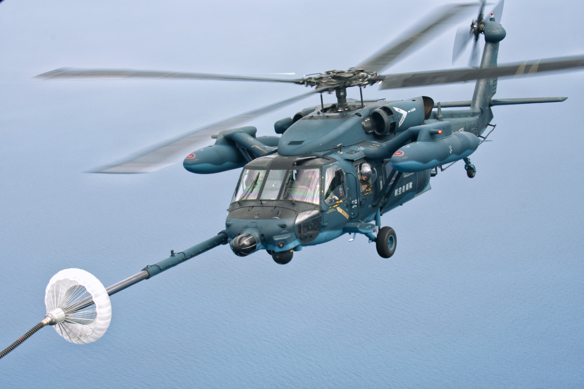 Japan Air Self-Defense Force UH-60J Black Hawk helicopter from the Komatsu Air Base prepares a Helicopter Air-to-Air Refueling June 5, 2014 above the Sea of Japan during HAAR training. This is the first time that members of the 353rd SOG held HAAR training with JASDF members in Honshu Island in Japan. (U.S. Air Force photo by Osakabe Yasuo/Released) 