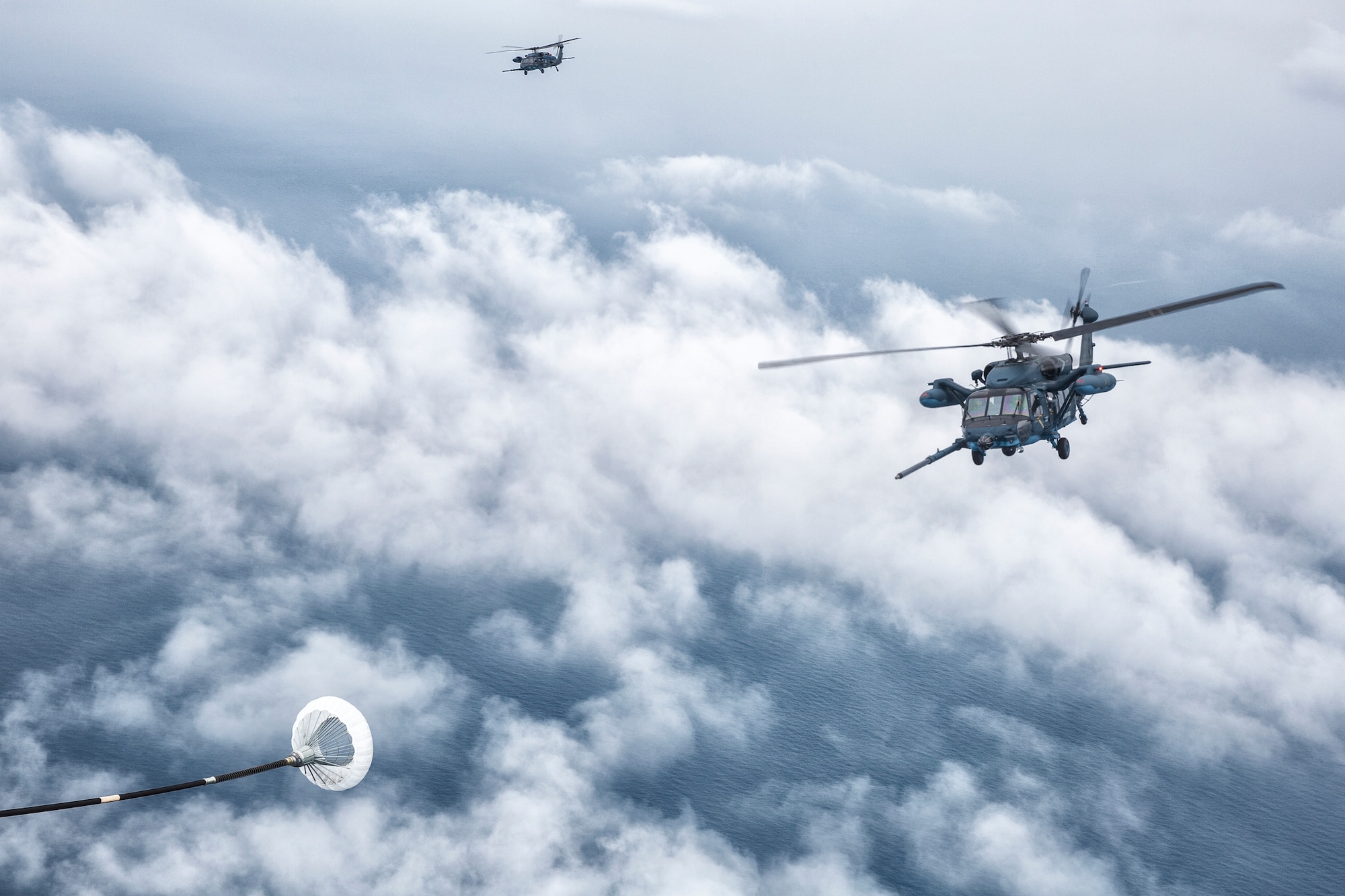An MC-130P Combat Shadow crew prepares to refuel two Japan Air Self-Defense Force UH-60J Black Hawk helicopters June 5, 2014, above the Sea of Japan. This is the first time that members of the 353rd SOG held HAAR training with Japan Air Self-Defense Force members on Honshu Island in Japan. (U.S. Air Force photo by Osakabe Yasuo/Released) 