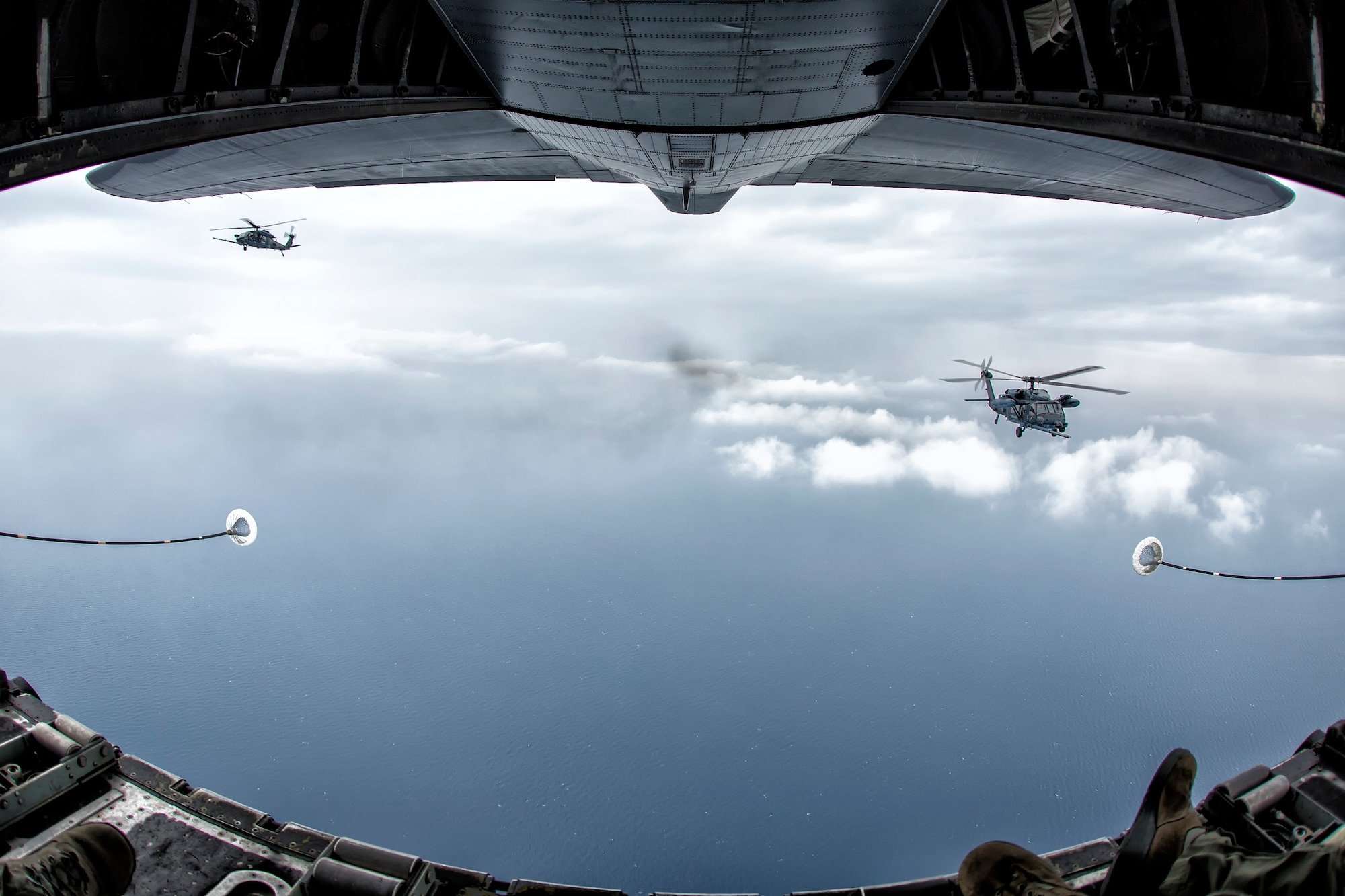 An MC-130P Combat Shadow crew prepares to refuel two Japan Air Self-Defense Force UH-60J Black Hawk helicopters June 5, 2014, above the Sea of Japan. This is the first time that members of the 353rd SOG held HAAR training with Japan Air Self-Defense Force members on Honshu Island in Japan. (U.S. Air Force photo by Osakabe Yasuo/Released) 