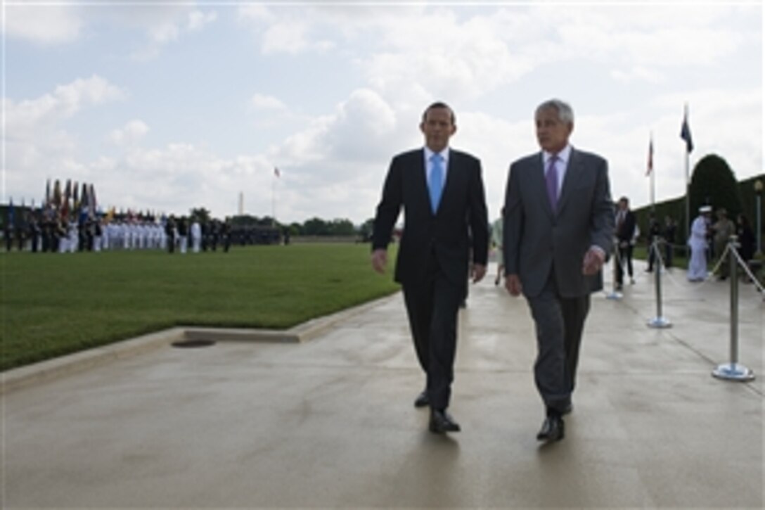 U.S. Defense Secretary Chuck Hagel, right, walks with Australian Prime Minister Tony Abbott after hosting a full-honors ceremony to welcome him to the Pentagon, June 13, 2014. The two leaders met to discuss issues of mutual importance.