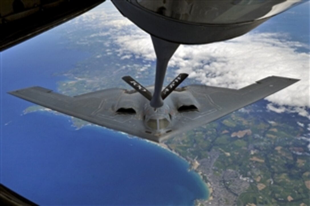 A B-2 Spirit from Whiteman Air Force Base, Mo., performs air refueling with a KC-135 Stratotanker from Royal Air Force Mildenhall over Cornwall, England, June 11, 2014. Whiteman is participating in familiarization training operations while deployed to England.