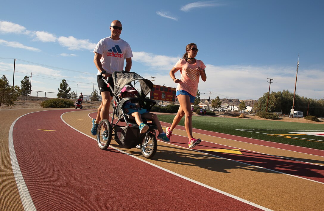 Staff Sgt. Taylor Stevenson, Joint Terminal Attack Controller evaluator, Tactical Training Exercise Control Group, runs with his daughter, Ava Stevenson, 3, and his wife, Brittany Stevenson, during the five-kilometer race in part of the annual Remembrance Run hosted at Felix Luke Field, May 29, 2014.

