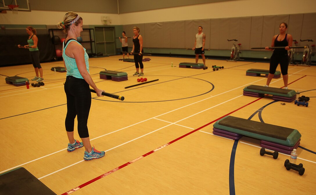 Marlena Mcguire, Cycle instructor, Community Center, leads a class in bicep curls during a Cardio Strength session hosted at the Community Center, June 9, 2014. The class improved cardiovascular endurance and strength by keeping the entire class active and participants’ bodies in motion with light weights and many repetitions.



