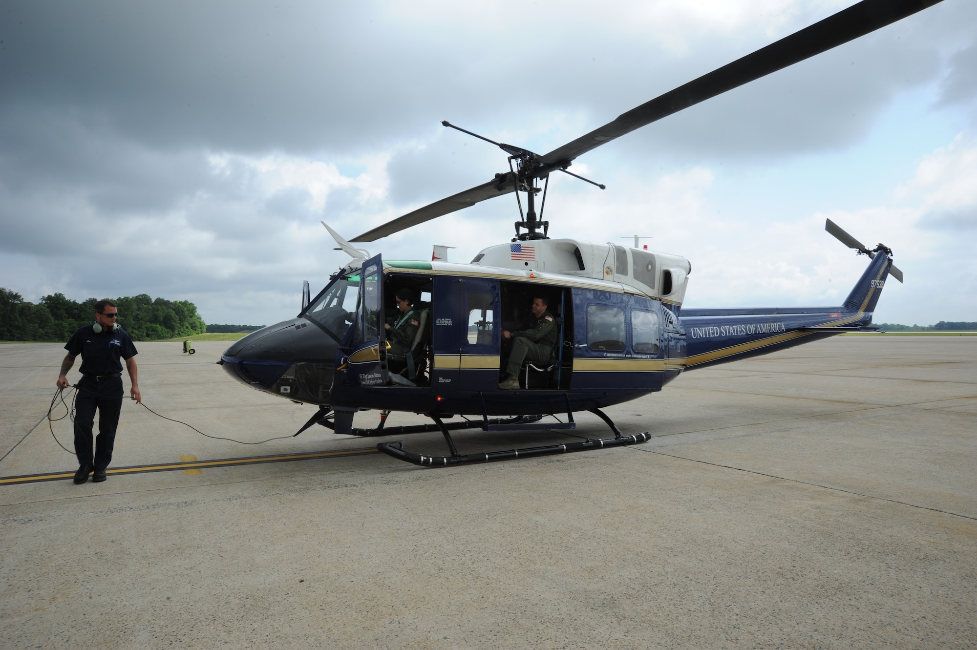 Jon Nelson preforms a preflight inspection before Air Force District of Washington Commander Maj. Gen. Sharon K. G. Dunbar takes off on her fini-flight at Joint Base Andrews, Md., June 13, 2014. Dunbar will retire from the Air Force after 32 years of service next month. Nelson works for the Dynacorp International Andrews Support Division. (U.S. Air Force photo/Master Sgt. Tammie Moore)