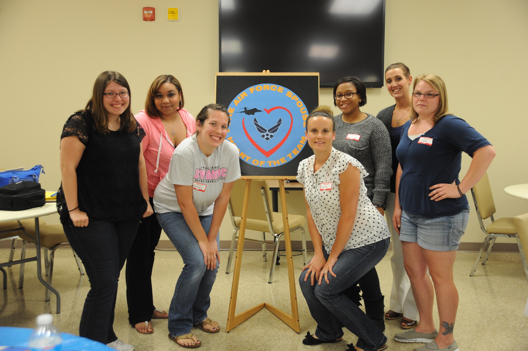 Team Dover spouses pose for a group photo with the Heart Link seal after participating in a Heart Link class June 12, 2014 at Dover Air Force Base, Del. The class is meant to help spouses better understand the Air Force and base agencies. (U.S. Air Force photo/Staff Sgt. Elizabeth Morris)