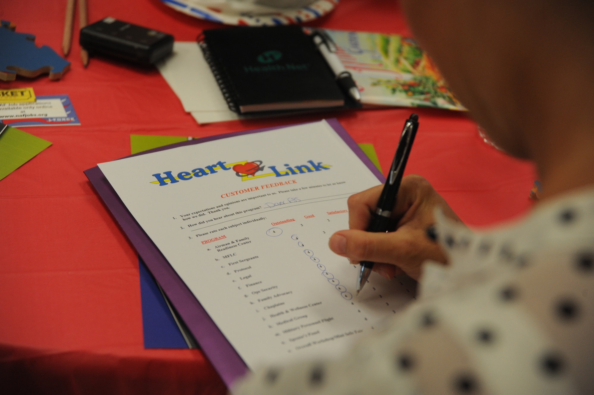 A Team Dover spouse fills out a customer feedback form after participating in a Heart Link class June 12, 2014 at Dover Air Force Base, Del. The class included briefings on the Airman and Family Readiness Center, Family Advocacy and many other base agencies. (U.S. Air Force photo/Staff Sgt. Elizabeth Morris)