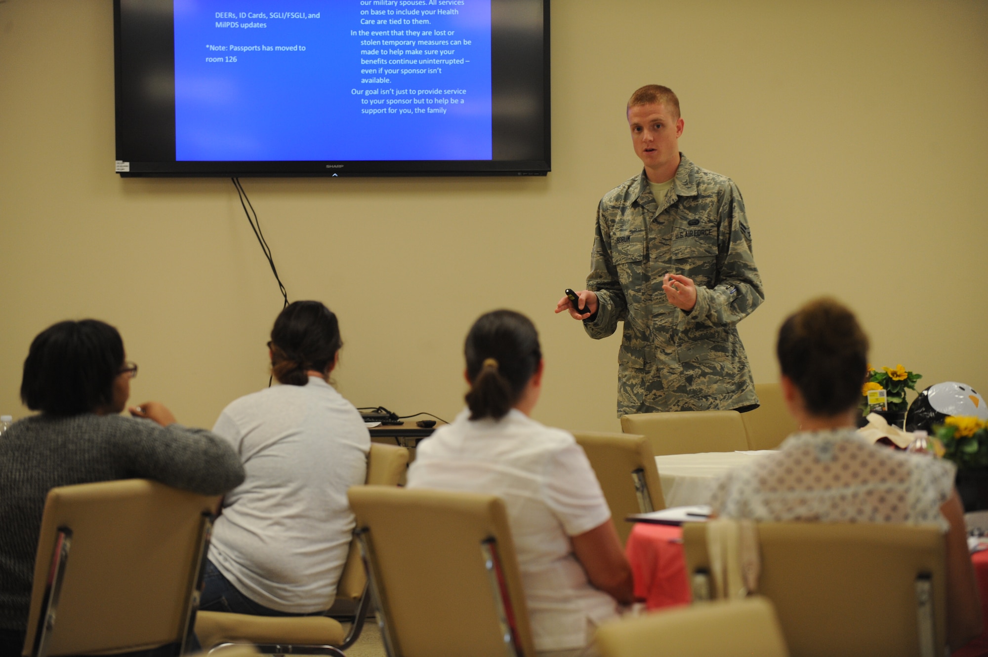 Airman 1st Class Ryan Borum, 436th Force Support Squadron personnelist, speaks to Team Dover spouses during Heart Link, a spouse orientation class sponsored by the Airman and Family Readiness Center and the Air Force Aid Society, June 12, 2014 at Dover Air Force Base, Del. Heart Link is targeted at spouses that are new to the military lifestyle and familiarizes them with base agencies and their functions. (U.S. Air Force photo/Staff Sgt. Elizabeth Morris)