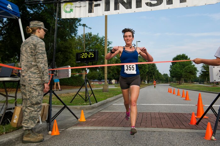 Ensign Jennifer Oblinger, Naval Nuclear Power Training Command instructor, finishes as the first place female during the Run the Runway 5K, June 14, 2014, at Joint Base Charleston, S.C. The event fostered relationships with members of the surrounding community, while raising awareness about Lou Gehrig’s disease and honoring Brig. Gen. Thomas Mikolajcik, who succumbed to the disease in 2010. Oblinger finished with a time of 20:27. (U.S. Air Force photo/Senior Airman George Goslin)