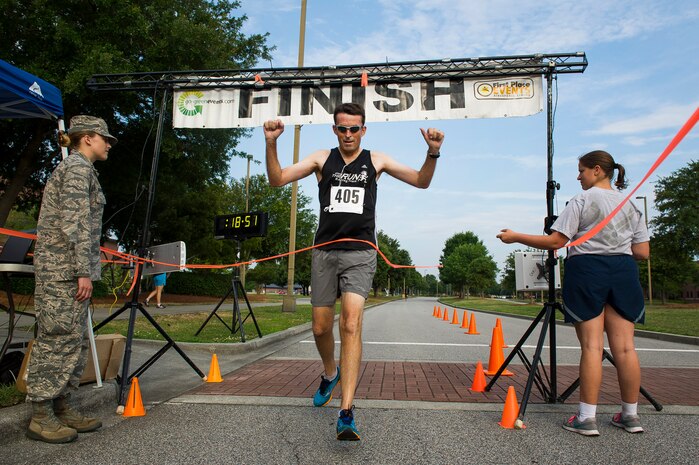 Michael Seekings, Charleston City Councilman, crosses the finish line in first place during the Run the Runway 5K, June 14, 2014, at Joint Base Charleston, S.C. The event fostered relationships with members of the surrounding community, while raising awareness about Lou Gehrig’s disease and honoring Brig. Gen. Thomas Mikolajcik, who succumbed to the disease in 2010. Seekings finished with a time of 18:52. (U.S. Air Force photo/Senior Airman George Goslin)