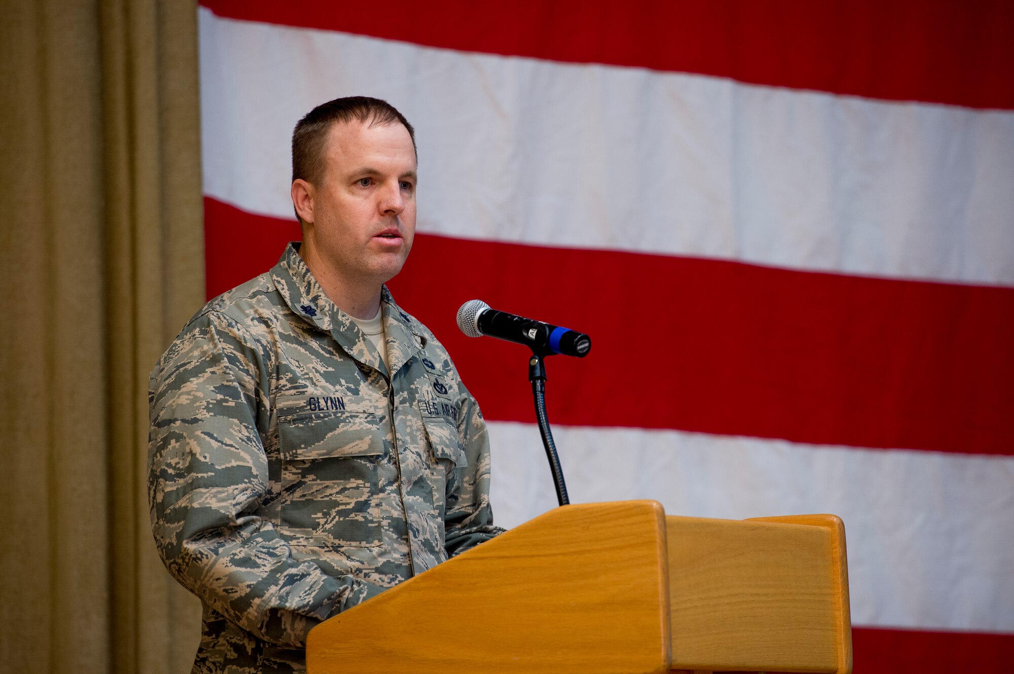 U.S. Air Force Lt. Col. Jason Glynn, 386th Expeditionary Civil Engineer Squadron commander, speaks to Airmen during a change of command ceremony June 11, 2014 at the Rock Theater at an undisclosed location in Southwest Asia. Glynn comes from Peterson Air Force Base, Colorado where he was the legislative affairs officer for the North American Aerospace Defense Command and United States Northern Command. (U.S. Air Force photo by Staff Sgt. Jeremy Bowcock)
