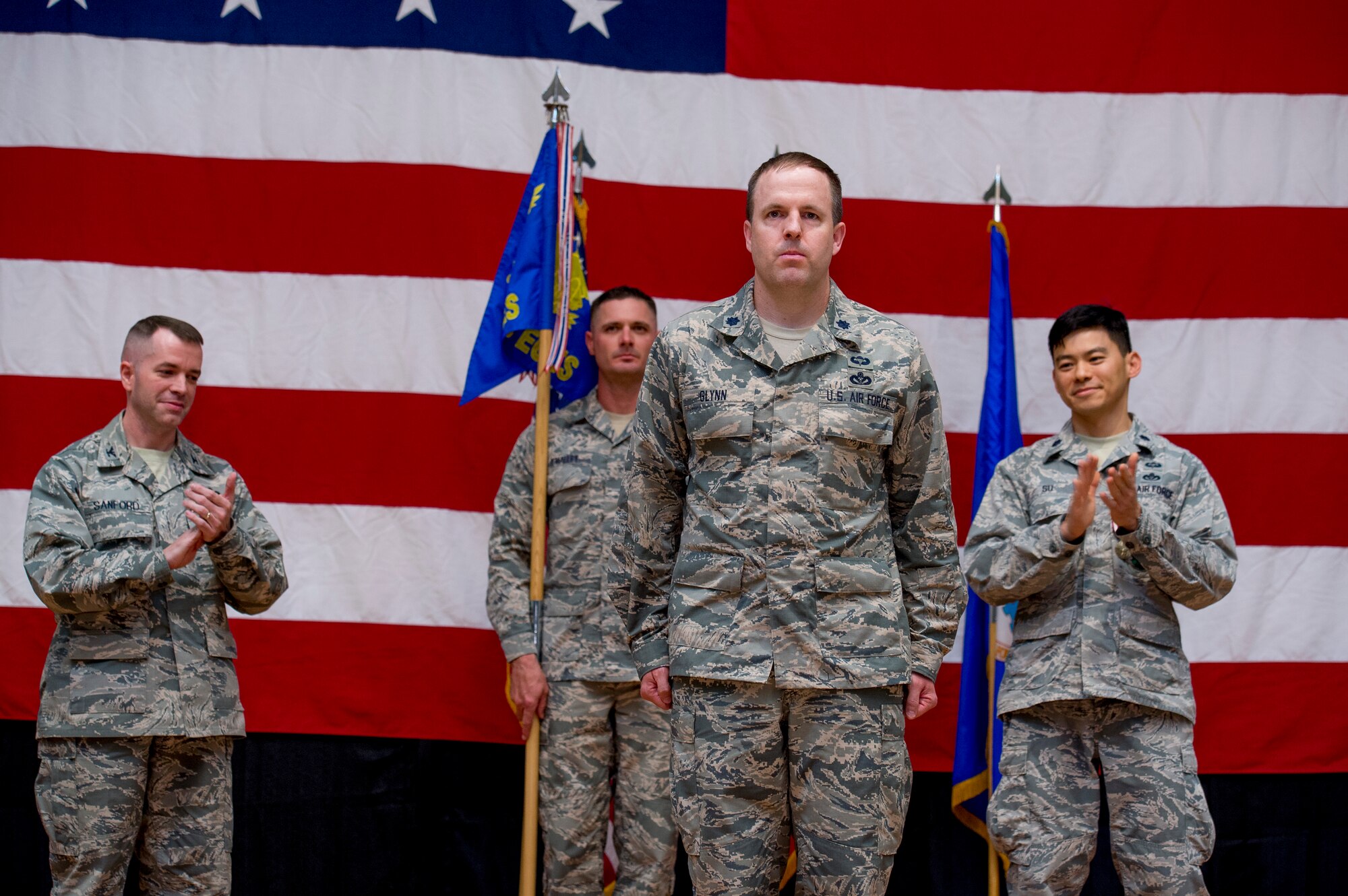 U.S. Air Force Lt. Col. Jason Glynn stands before his Airmen after assuming command of the 386th Expeditionary Civil Engineer Squadron June 11, 2014 at the Rock Theater at an undisclosed location in Southwest Asia. Glynn comes from Peterson Air Force Base, Colorado where he was the legislative affairs officer for the North American Aerospace Defense Command and U.S. Northern Command. (U.S. Air Force photo by Staff Sgt. Jeremy Bowcock)