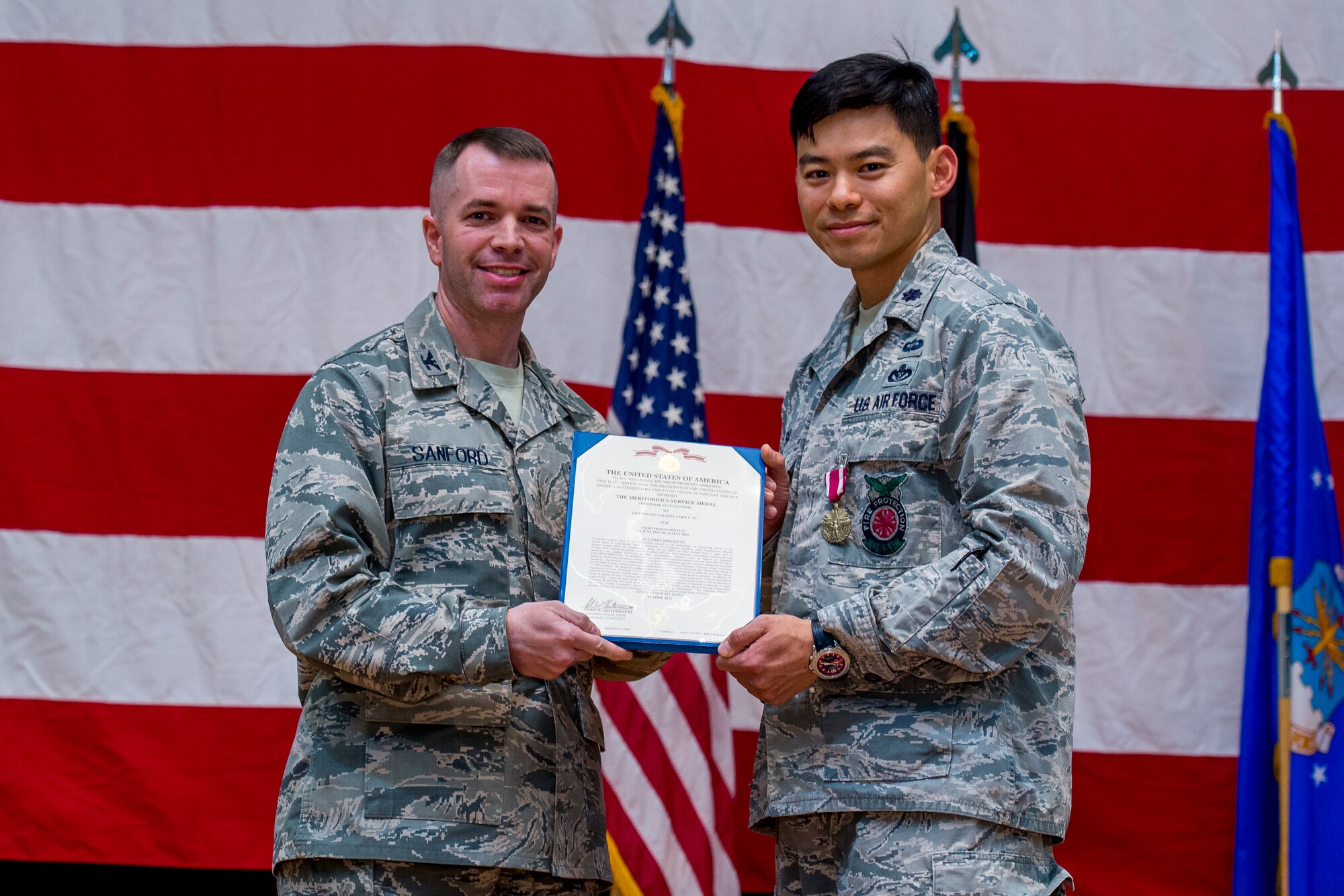 U.S. Air Force Lt. Col Chen Y. Su, 386th Expeditionary Civil Engineer Squadron commander, receives the Air Force Meritorious Service Medal during a change of command ceremony June 11, 2014 at the Rock Theater at an undisclosed location in Southwest Asia. (U.S. Air Force photo by Staff Sgt. Jeremy Bowcock)