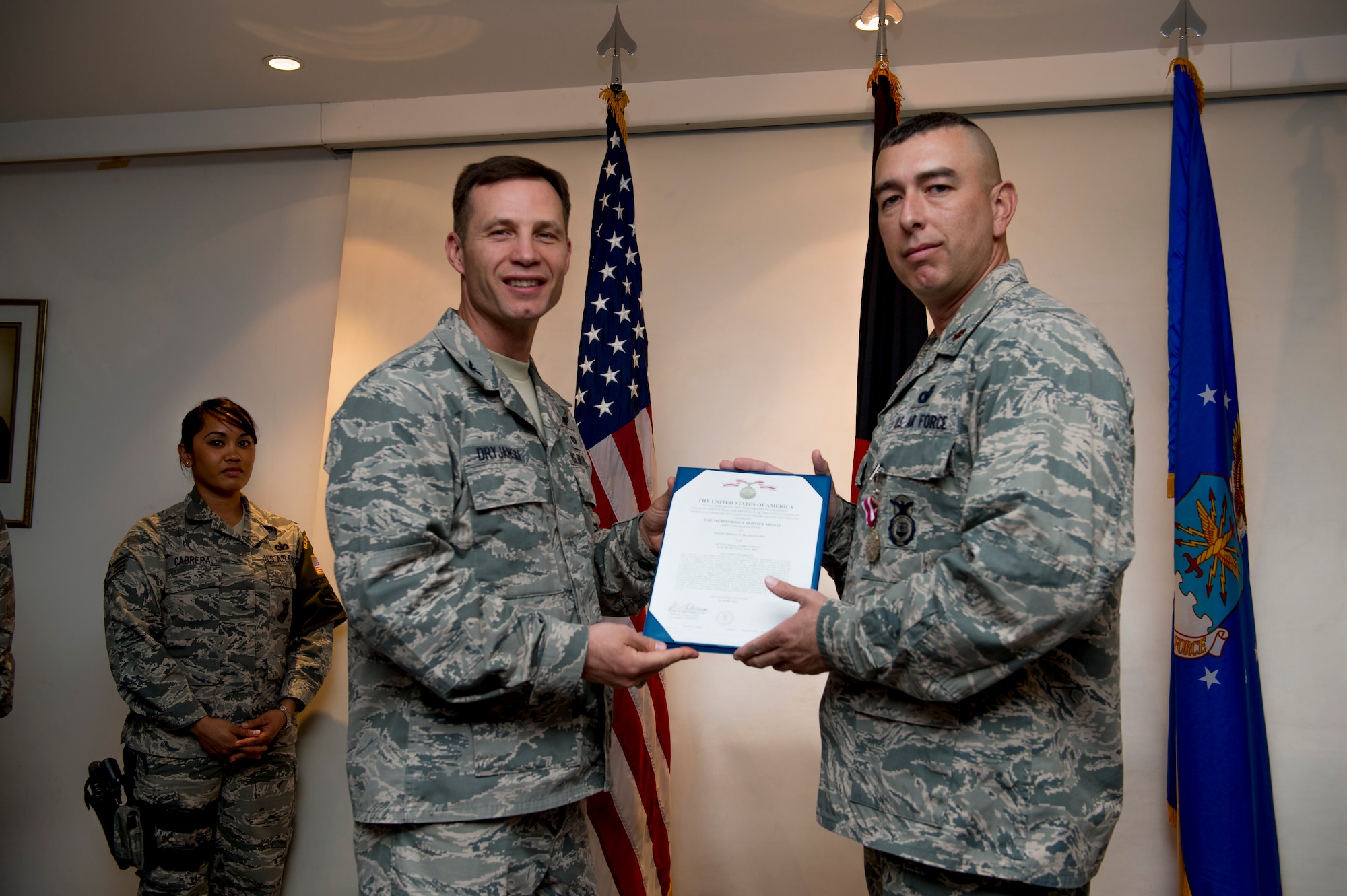 U.S. Air Force Maj. Thomas McGillicuddy, 387th Expeditionary Security Forces Squadron commander, receives the Air Force Meritorious Service Medal during a change of command ceremony June 12, 2014 at an undisclosed location in Southwest Asia. McGillicuddy will be moving on to Vance Air Force Base, Oklahoma where he will command the 71st Security Forces Squadron. (U.S. Air Force photo by Staff Sgt. Jeremy Bowcock)