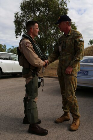 Lt Col. Shawn Basco, commanding officer of Marine All-Weather Fighter Attack Squadron 242, left, shakes hands with wing commander Mark Larter, the senior Australian defense officer for Royal Australian Air Force Base Tindal, Australia, June 6, 2014, upon arrival aboard base. Marine with VMFA(AW)-242 arrived in Australia as part of Exercise Southern Frontier 14, an annual bilateral training exercise between the RAAF and the United States Marine Corps with a primary focus on offensive air support.