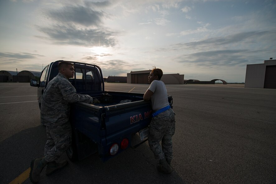 Senior Airman Kayla Dale, a 51st Maintenance Squadron non-destructive inspector, chats with coworker Senior Airman Chad Smithwick, before a job June 4, 2014, at Osan Air Base, Republic of Korea. NDI inspects numerous planes on base, and is reponsible for identifying flaws or deficincies in their parts. (U.S. Air Force photo by Staff Sgt. Jake Barreiro)