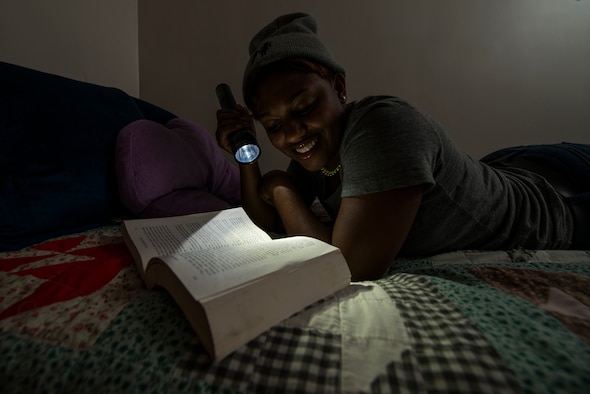 Senior Airman Kayla Dale, 51st Maintenance Squadron non-destructive inspector, reads a book in her dorm room June 13, 2014, at Osan Air Base, Republic of Korea. Dale credits her hobbies of reading and writing with keeping her out of trouble and inspiring her to dream big as a child. (U.S. Air Force photo by Staff Sgt. Jake Barreiro)