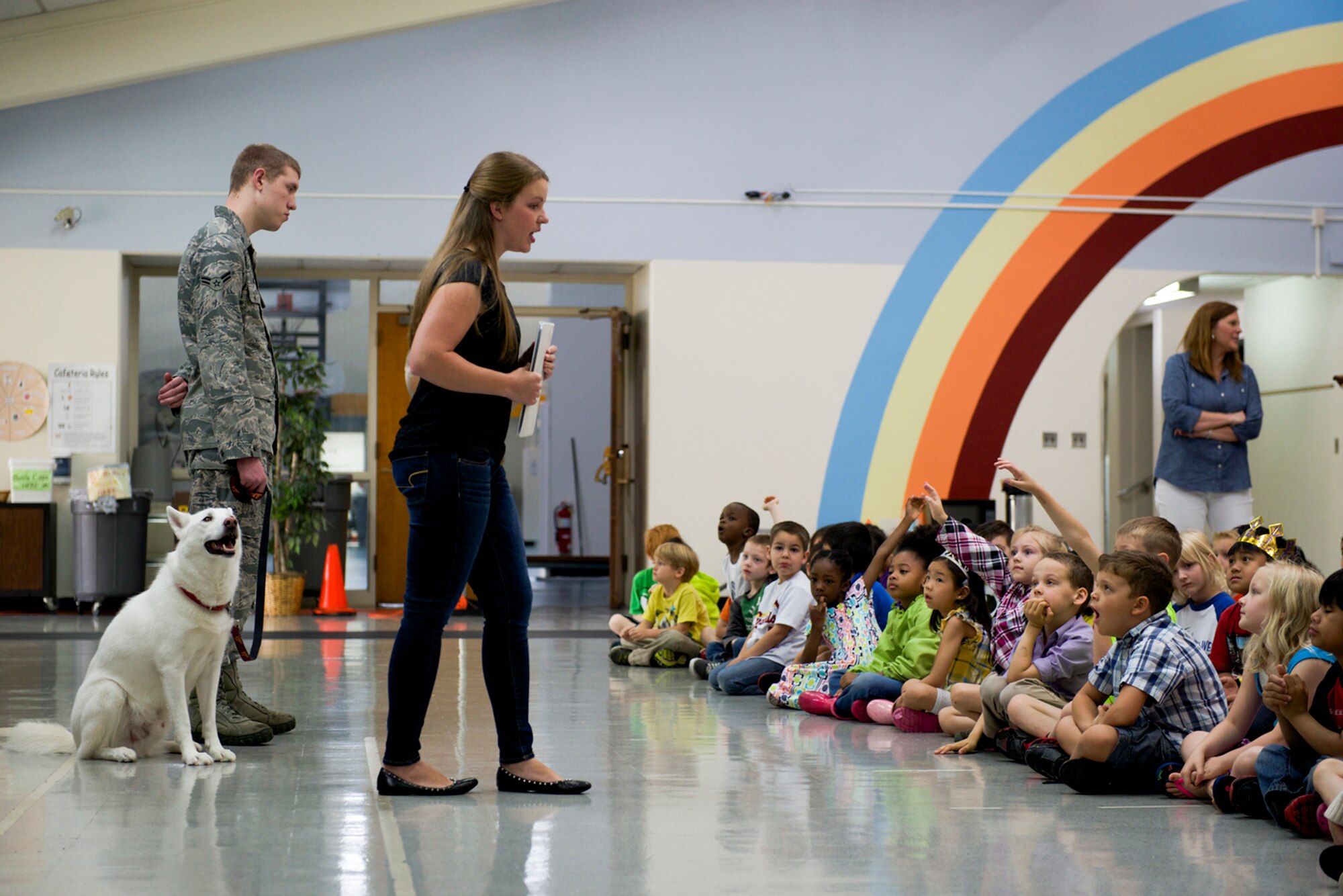 Kirsten Machamer, 374th Aerospace Medicine Squadron public health volunteer and dog trainer, answers questions from students at Yokota West Elementary school during a dog safety briefing at Yokota Air Base, Japan, June 12, 2014. The presentation aimed to reduce the risk of an accidental dog bite. (U.S. Air Force photo by Airman 1st Class David Danford/Released)