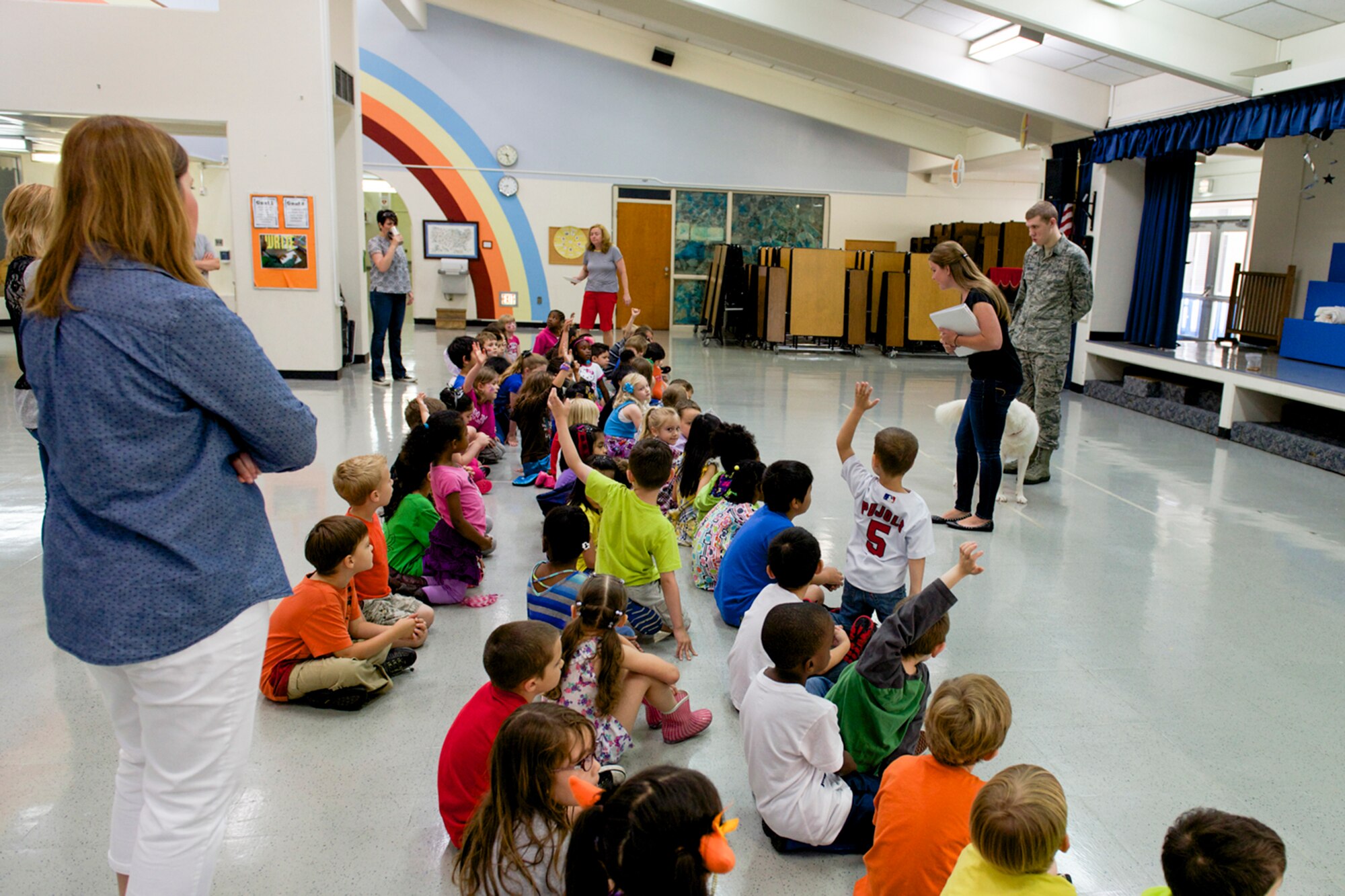 Kirsten Machamer, 374th Aerospace Medicine Squadron public health volunteer and dog trainer, teaches dog safety practices to children school  at Yokota West Elementary at Yokota Air Base, Japan, June 12, 2014. The class focused on dog behaviors and the importance of asking a dog’s owner before approaching their pet. (U.S. Air Force photo by Airman 1st Class David Danford/Released)