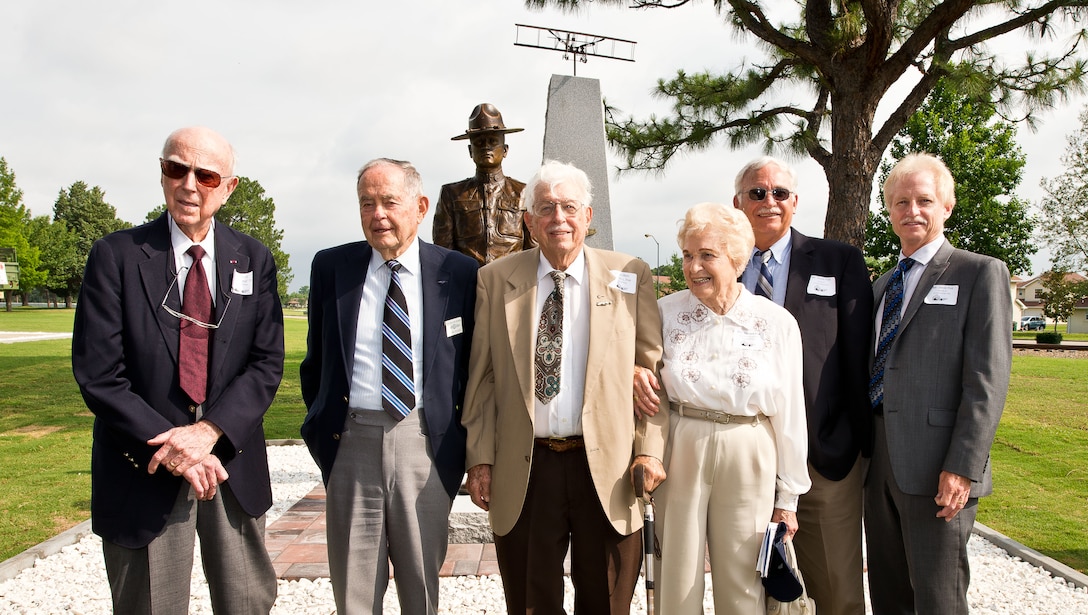 From left: Retired pilots Col. James "Pat" Pool, Lt. Col. John Beard, and Lt. Col. Charles Fisk and family members, stand in front of the new enlisted pilot monument at Maxwell-Gunter Air Force Base, June 9, 2014. The monument honored the nearly 3,000 enlisted sergeant pilots, including Pool, Beard and Fisk, who served in the military from 1912-1957. (U.S. Air Force photo by Donna Burnett)