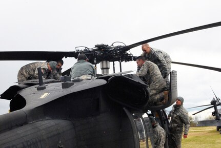 Connecticut Army National Guard Soldiers from D Company, 1-169th Aviation Regiment, perform routine inspection and maintenance on the tail end of a UH-60 Black hawk helicopter at a Canadian army training site in Gagetown, New Brunswick, May 12, 2012. The Soldiers were training in Canada as a part of their two-week annual training exercise.