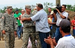 Army South's Task Force Tropic, commanded by Army Lt. Col. Robert L. Jones, Missouri Army National Guard, and Leonidas Matamoros, a community leader who had been instrumental in getting this project for his community, thanked each for their mutual help in building a school, in Micheletti, Honduras, May 8, 2012.