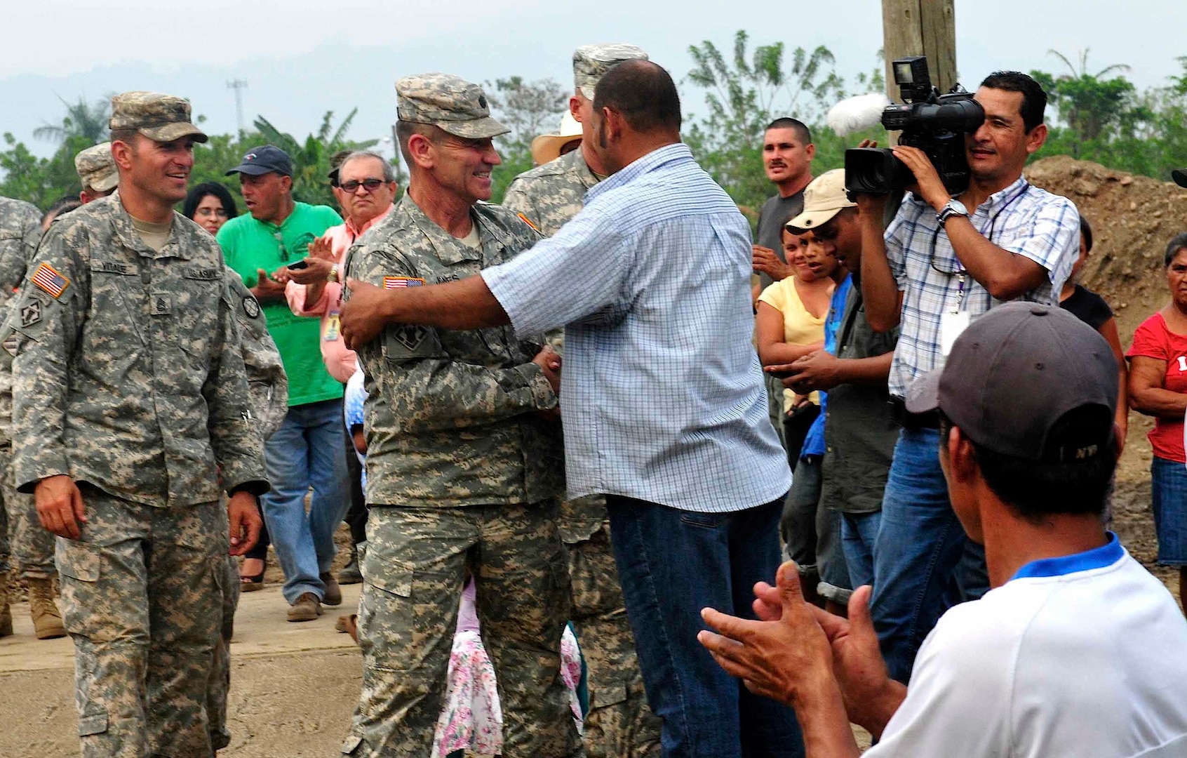 Army South's Task Force Tropic, commanded by Army Lt. Col. Robert L. Jones, Missouri Army National Guard, and Leonidas Matamoros, a community leader who had been instrumental in getting this project for his community, thanked each for their mutual help in building a school, in Micheletti, Honduras, May 8, 2012.