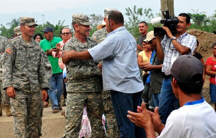 Army South's Task Force Tropic, commanded by Army Lt. Col. Robert L. Jones, Missouri Army National Guard, and Leonidas Matamoros, a community leader who had been instrumental in getting this project for his community, thanked each for their mutual help in building a school, in Micheletti, Honduras, May 8, 2012.