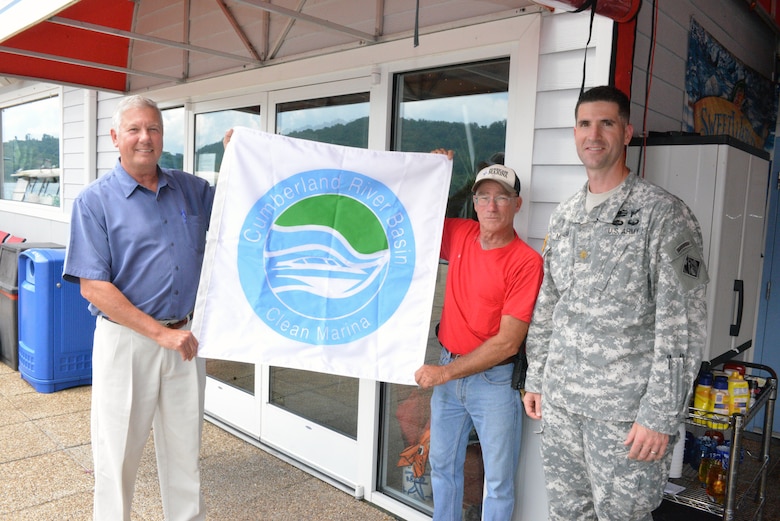 Maj. Brad Morgan (Right), Nashville District deputy commander, presents the “Clean Marina” flag to Hurricane Marina Owner Alan Seilbeck (Left) and Marina Manager Bill Sloan June 12, 2014.  