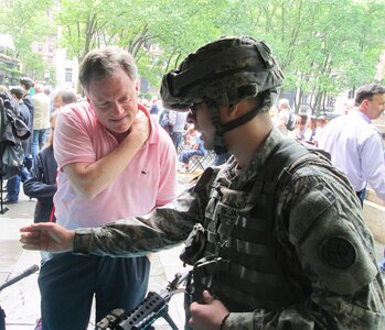 New York Army National Guard Spc. Erik Grijalva instructs a visitor on the proper way to handle an M-249 Squad Automatic Weapon during a weapons and equipment display the unit hosted as part of the Army's celebration of its 239th Birthday on June 14, 2014. Gen. Raymond Odierno, the Chief of Staff of the Army, took part in the event, held on June 13 in Bryant Park.