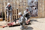 Wisconsin Army National Guard combat medics quickly assess a battle-damaged mannequin in an urban combat setting during a two-day Army Medical Department (AMEDD) training session at Fort McCoy, Wis., May 19 to 20, 2012. Realistic training events - such as extracting wounded Soldiers from an urban combat zone and from a guard tower, litter obstacles, battalion aid station and loading casualties on air and ground medevac vehicles - reinforced core skills for more than 200 combat medics and other military medical professionals.