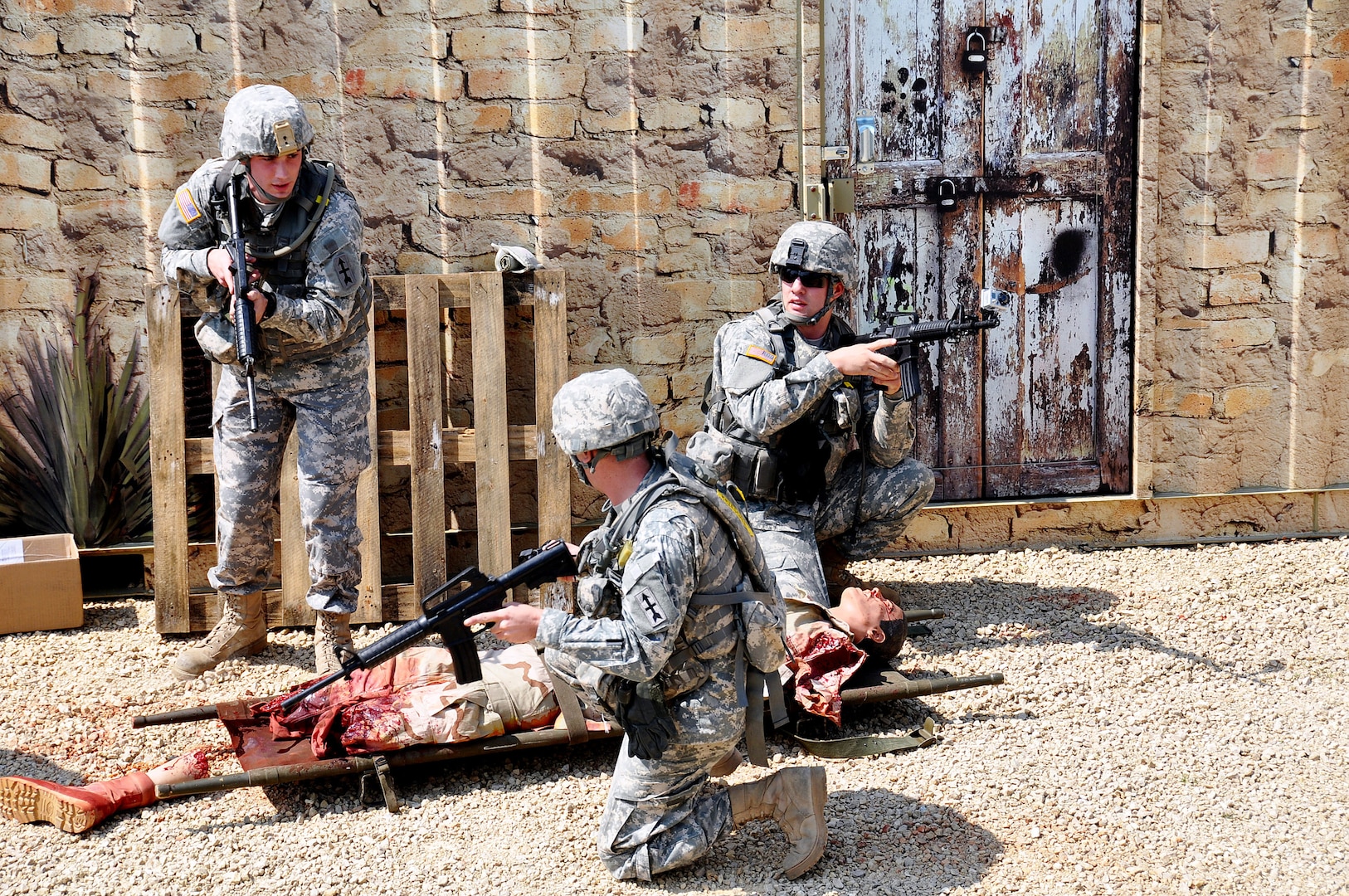 Wisconsin Army National Guard combat medics quickly assess a battle-damaged mannequin in an urban combat setting during a two-day Army Medical Department (AMEDD) training session at Fort McCoy, Wis., May 19 to 20, 2012. Realistic training events - such as extracting wounded Soldiers from an urban combat zone and from a guard tower, litter obstacles, battalion aid station and loading casualties on air and ground medevac vehicles - reinforced core skills for more than 200 combat medics and other military medical professionals.