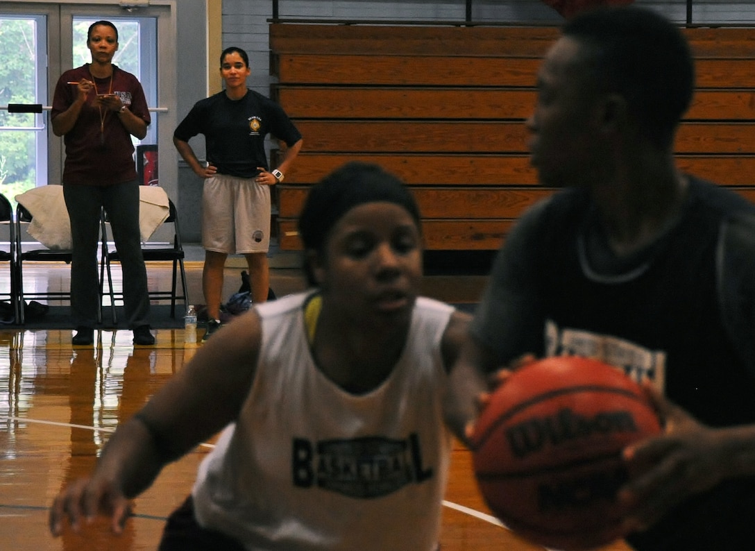 Assistant Coach Tonya Strobridge, Navy civilian stationed at Naval Air Station Millington, Tenn. and Army Capt. Vanessa Ramirez, a physician with 101st Brigade Support Battalion, 1st Infantry Division, Fort Riley, Kan., observe members of the Armed Forces Women’s Basketball team training on Fort Indiantown Gap, Pa., June 9. (U.S. Army National Guard photo by Maj. Angela King-Sweigart/Released)