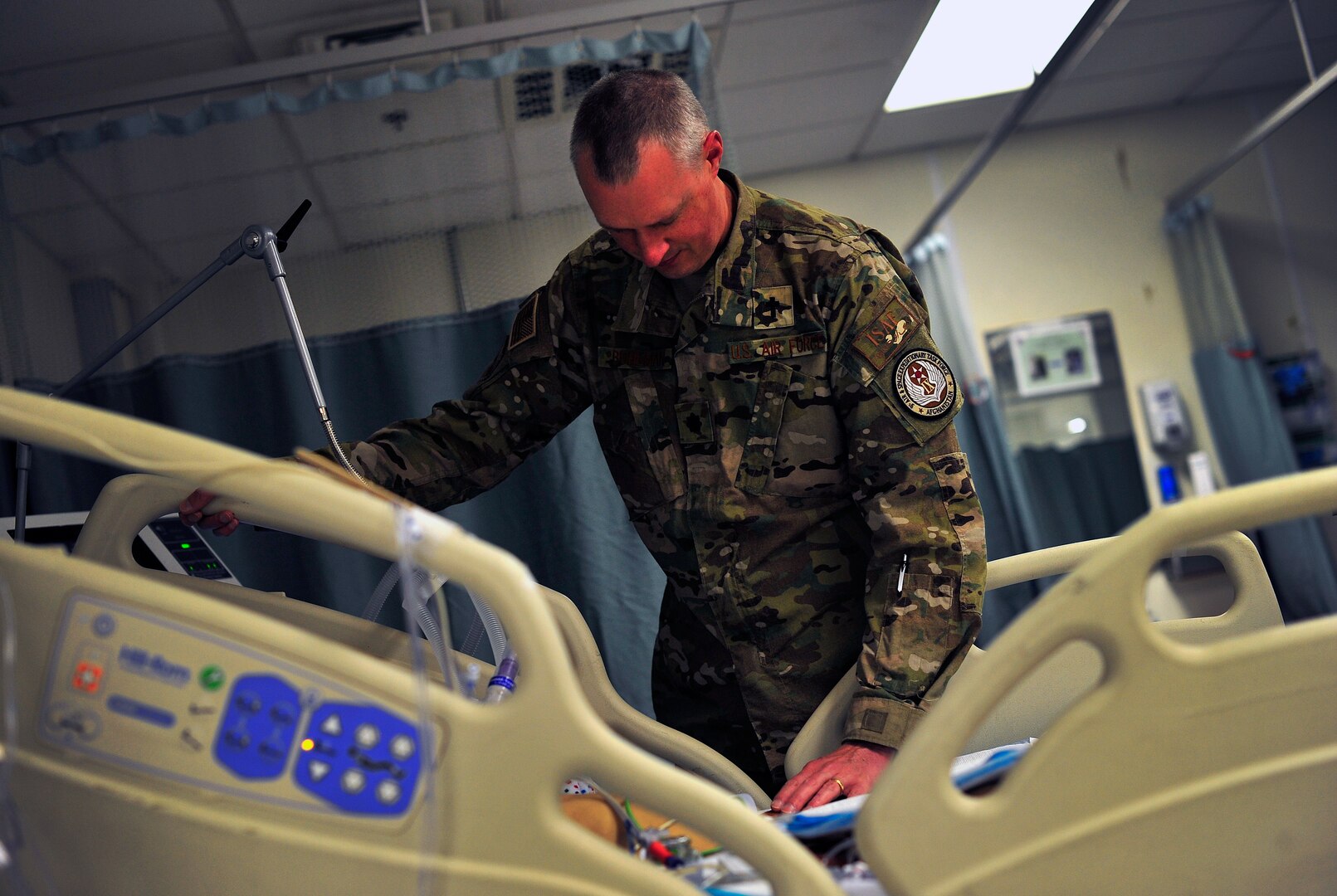 U.S. Air Force Lt. Col. Brian Bohlman, chaplain with the 455th Air Expeditionary Wing, Bagram Air Field, Afghanistan, meets with and prays with a severely injured Afghan girl at the Craig Joint Theater Hospital, May 26, 2012. Bohlman works the night shift at the hospital and routinely visits patients, American and Afghan, throughout the night helping them to cope with their circumstances. The hospital here employs 528 joint medical staff.